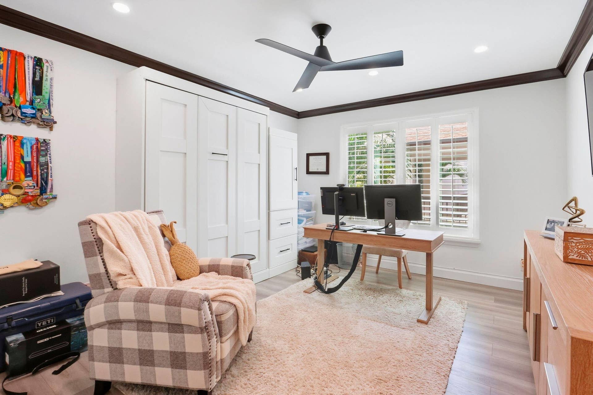 900 Greensward Lane, #209-G, Delray Beach, FL 33445 Recessed lighting, wood-finish flooring, white plantation shutters, built-in cabinetry, and a ceiling fan with integrated lighting