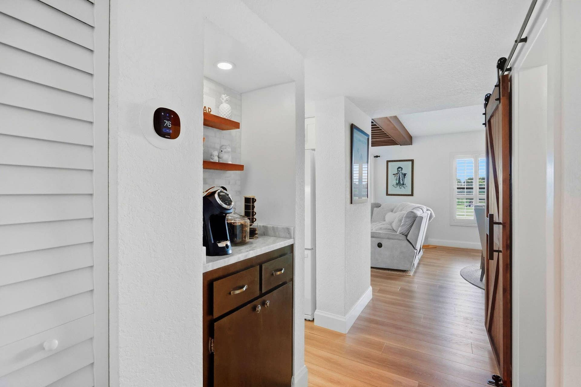 900 Greensward Lane, #209-G, Delray Beach, FL 33445 Built-in bar with wood-finish cabinetry, light-toned countertop, and open shelving