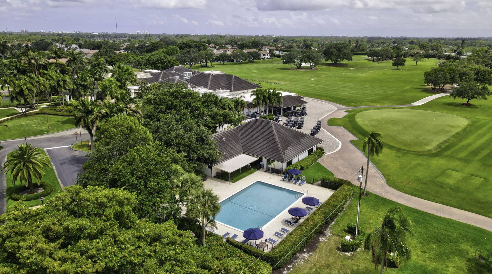 900 Greensward Lane, #209-G, Delray Beach, FL 33445 Community clubhouse with a swimming pool and expansive golf course