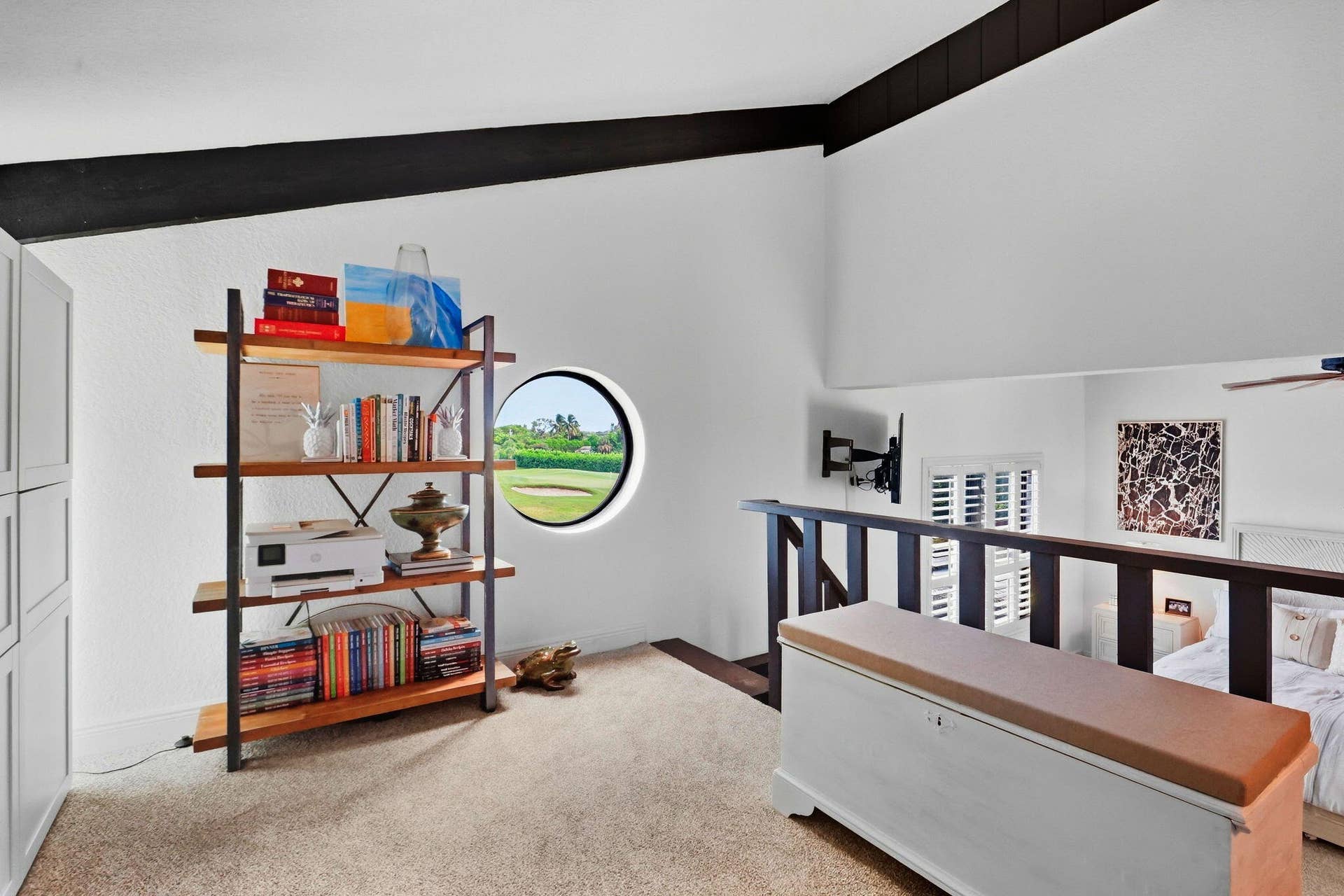 900 Greensward Lane, #209-G, Delray Beach, FL 33445 Vaulted ceilings with exposed beams, built-in shelving, circular porthole window, and a wooden railing