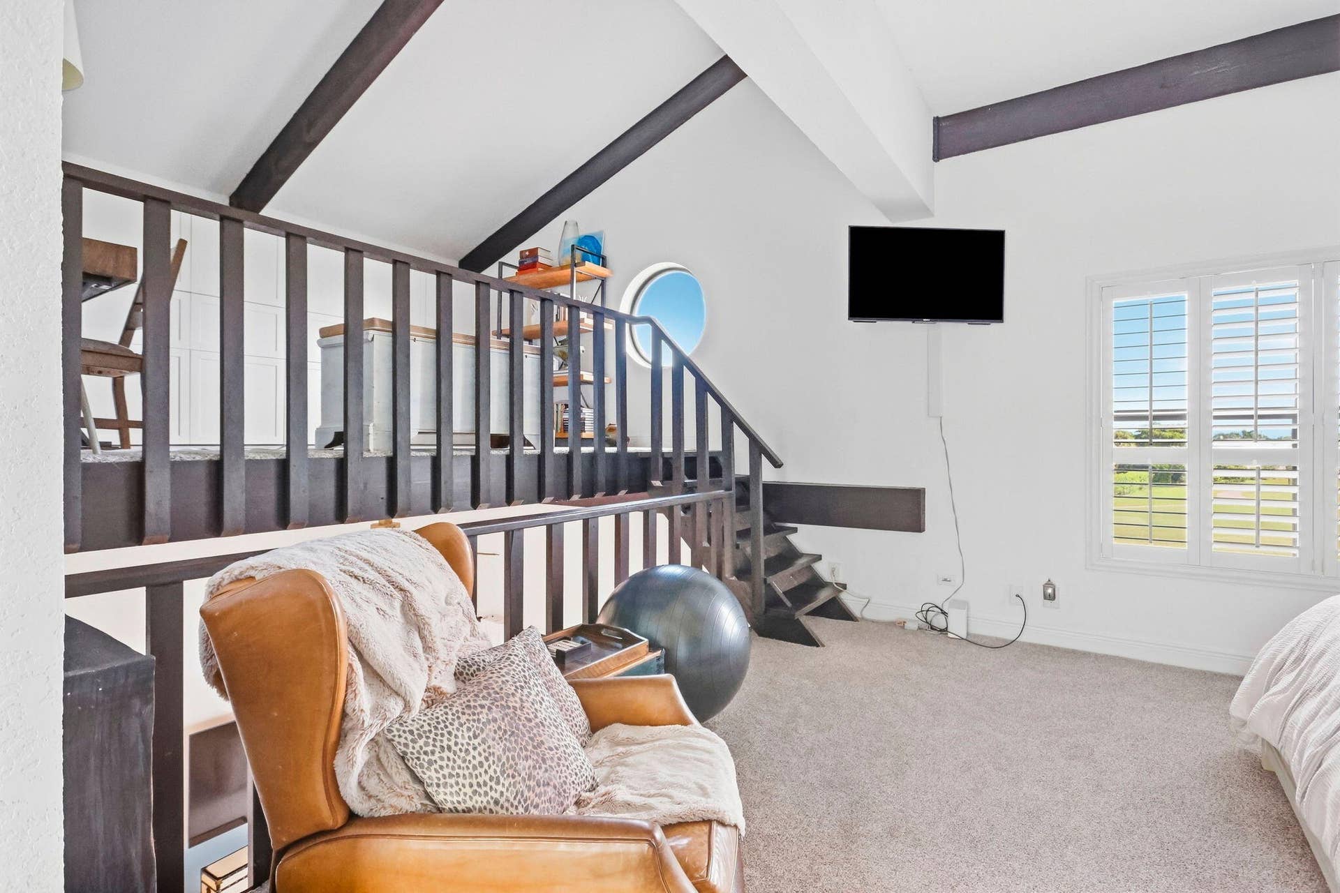 900 Greensward Lane, #209-G, Delray Beach, FL 33445 Loft area featuring exposed wood beams, a circular window, and carpet flooring