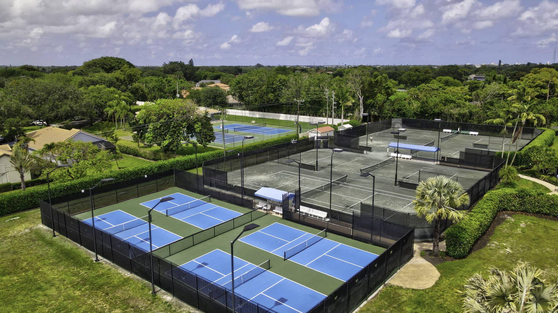 900 Greensward Lane, #209-G, Delray Beach, FL 33445 Multiple hard-surface courts, surrounded by fencing and mature landscaping
