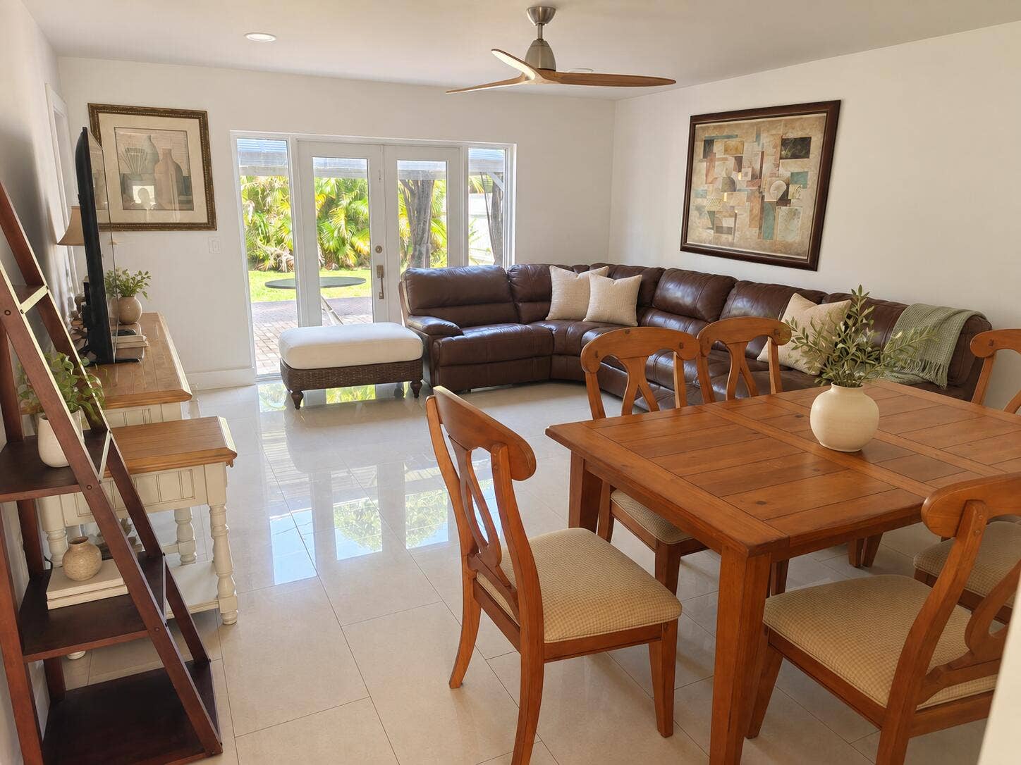 White tile flooring, a contemporary ceiling fan, recessed lighting, and French doors leading to an outdoor area