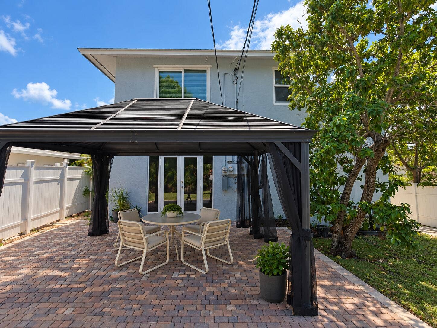 Private outdoor patio featuring a gazebo and brick paver flooring