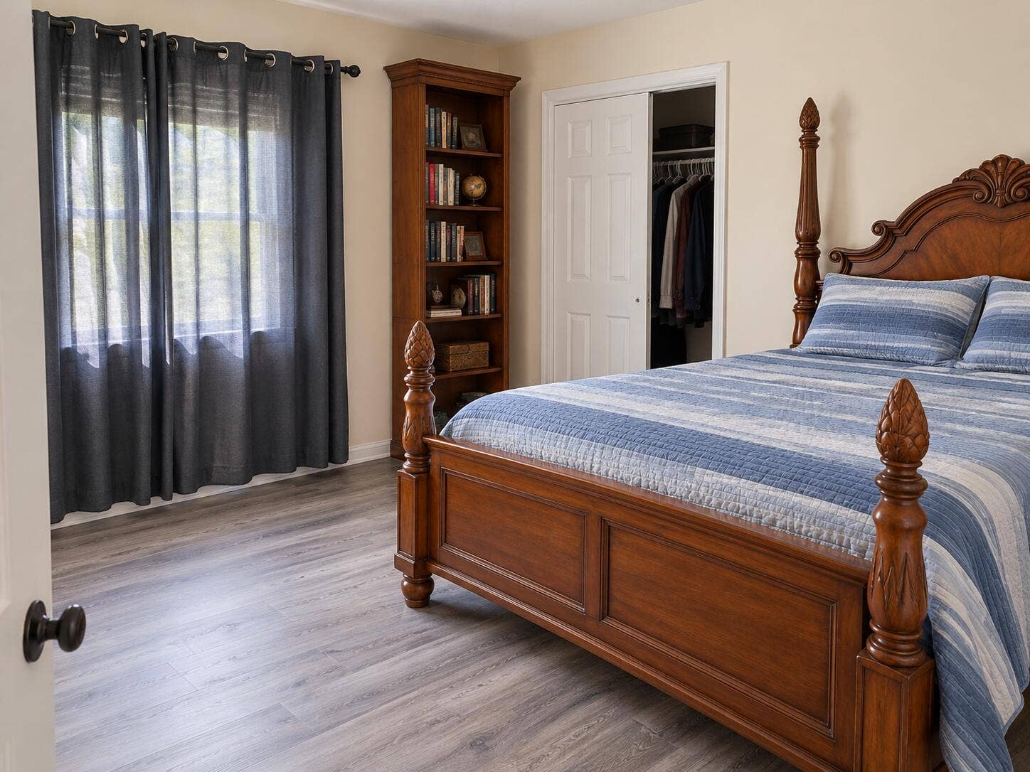 Light-toned wall paint, two-panel bifold closet doors, and wood-finish flooring