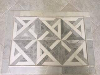 149 MOCCASIN Trail S, Jupiter, FL 33458 Decorative floor tile inlay featuring a geometric pattern and light-toned grout