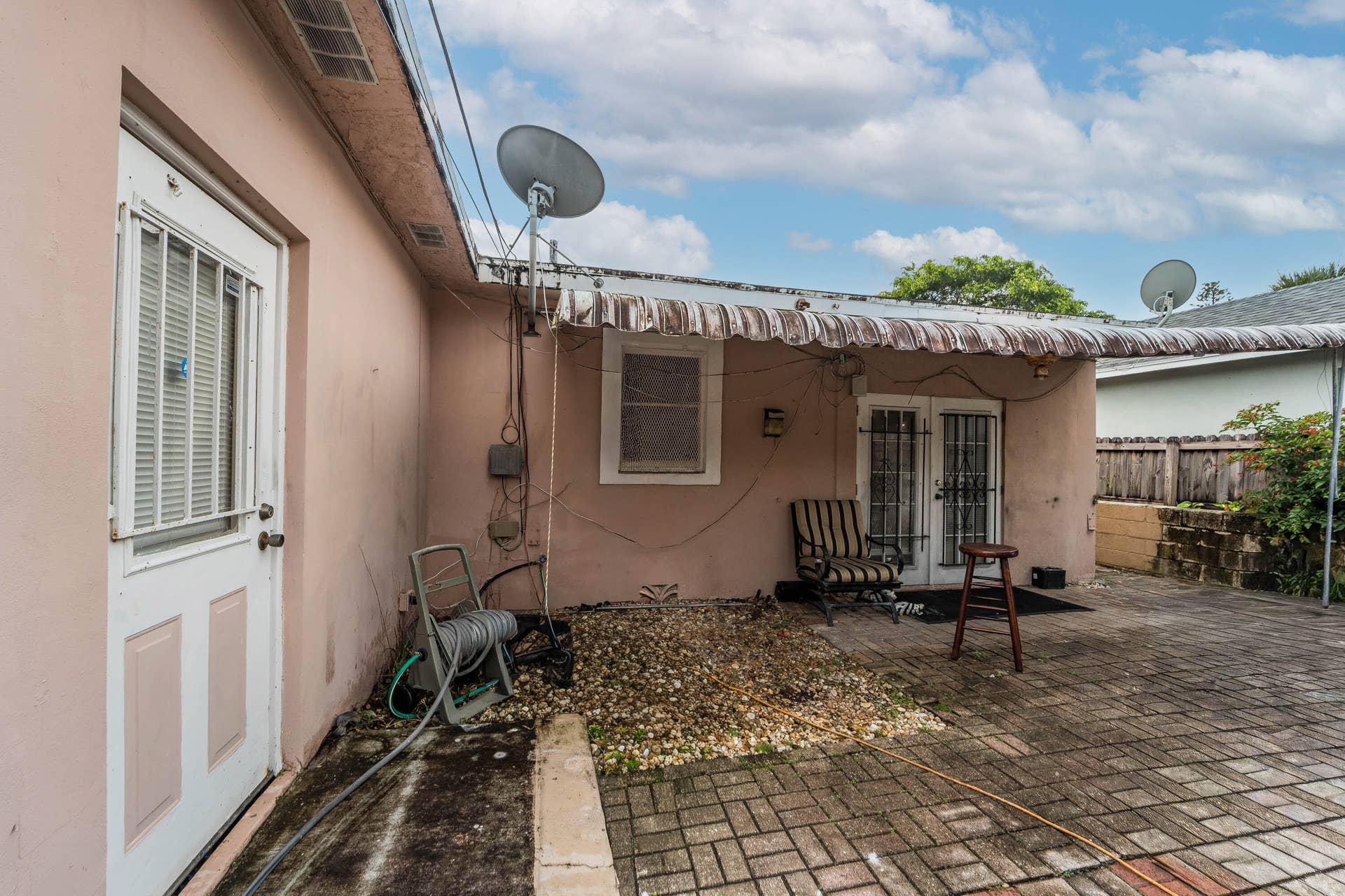 521 26TH Street, West Palm Beach, FL 33407 Covered backyard patio and doors that exits from bedroom 3 and the family room.