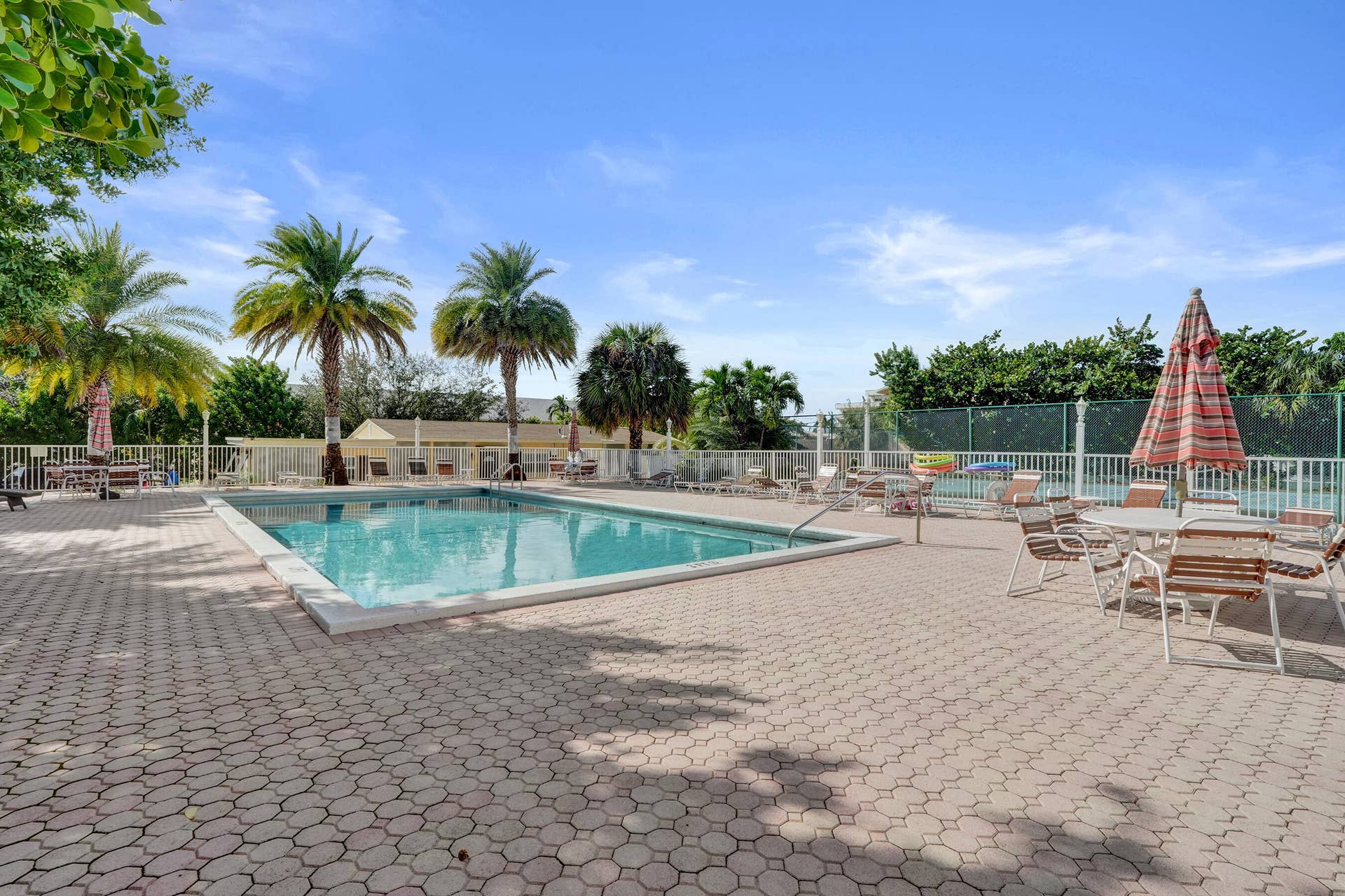 Tradewinds heated pool and spacious pool deck area.