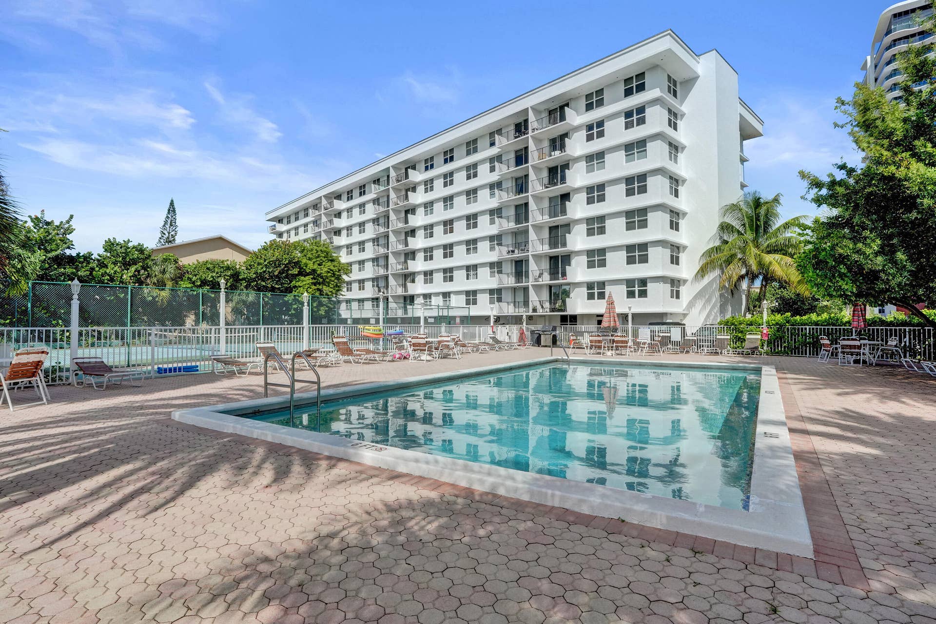 Tradewinds heated pool and spacious pool deck area.