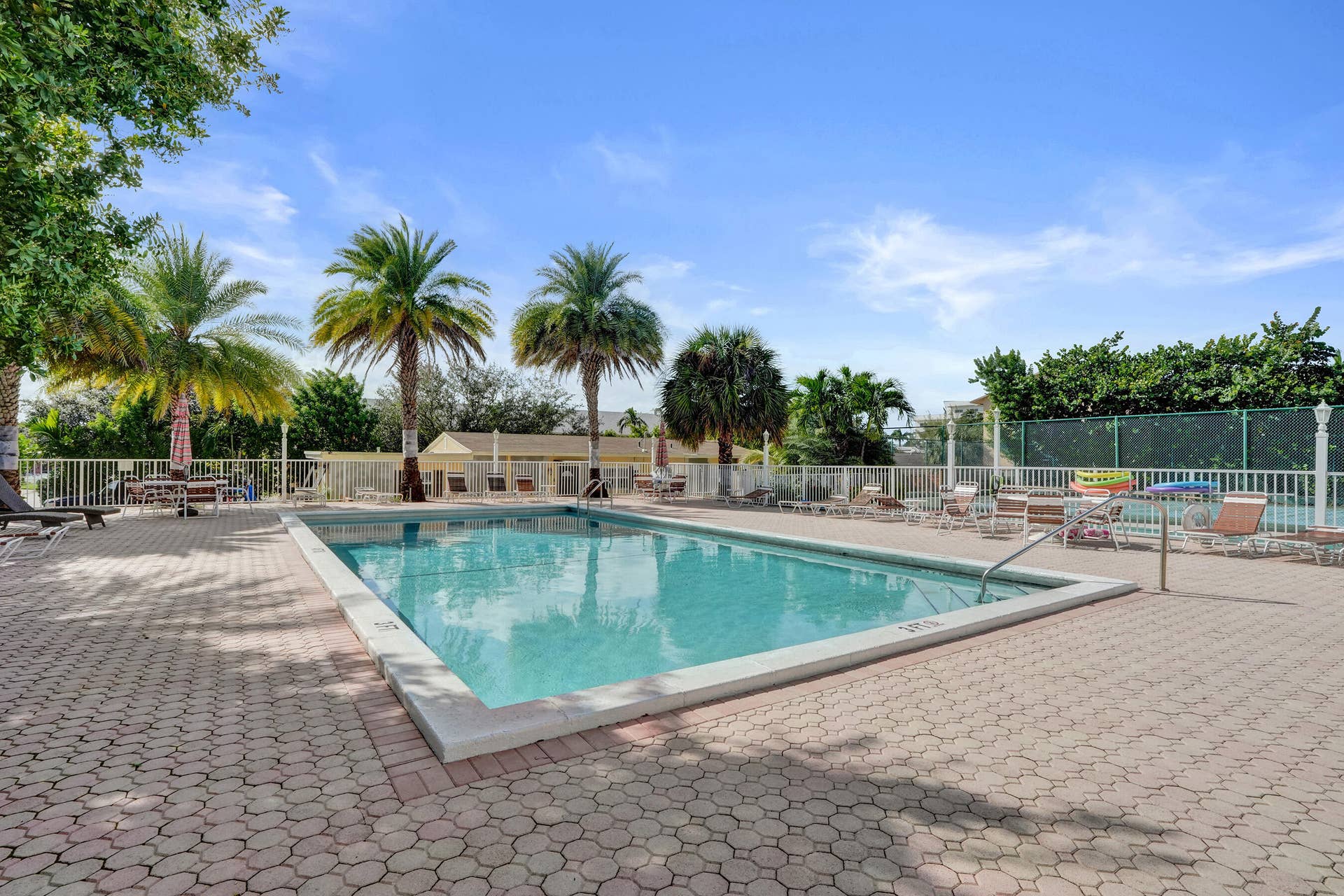 Tradewinds heated pool and spacious pool deck area.