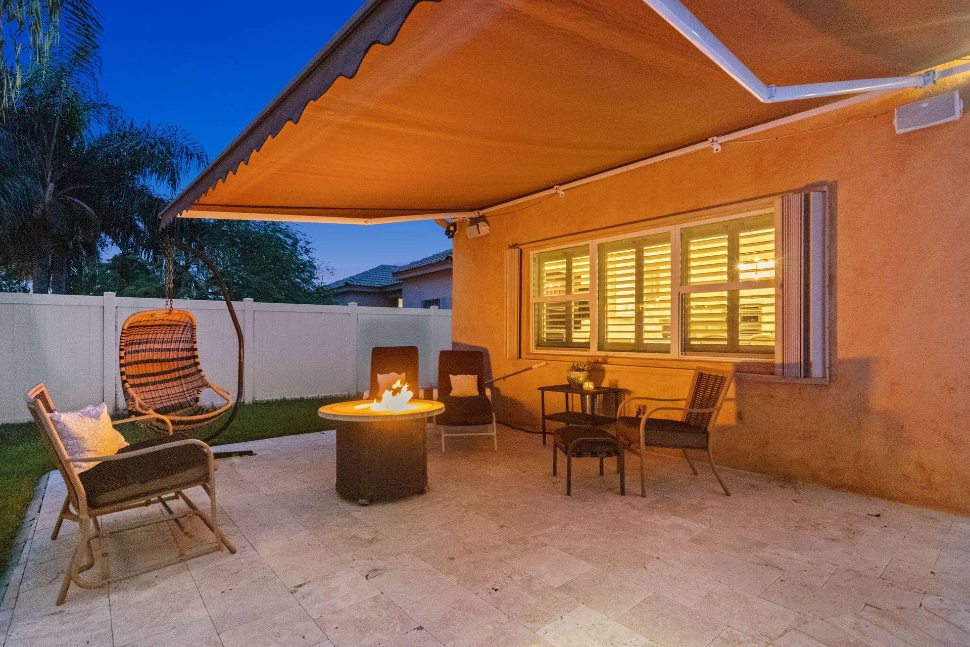 Another outdoor area with retractable awning and fire pit.