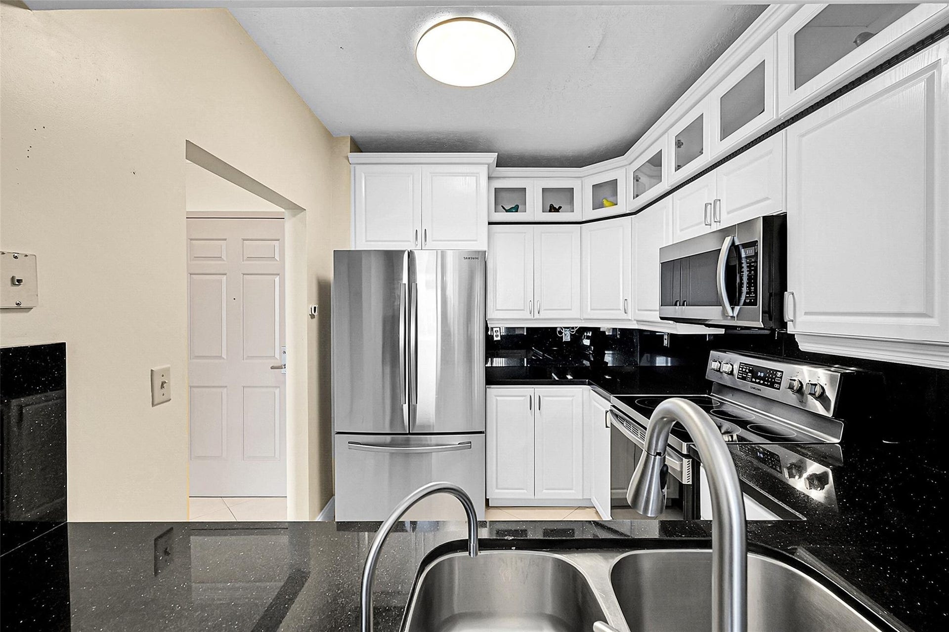 3020 NE 32ND Avenue, #805, Fort Lauderdale, FL 33308 Thoughtfully designed kitchen with a convenient pass through enhances the open flow and functionality of the home.