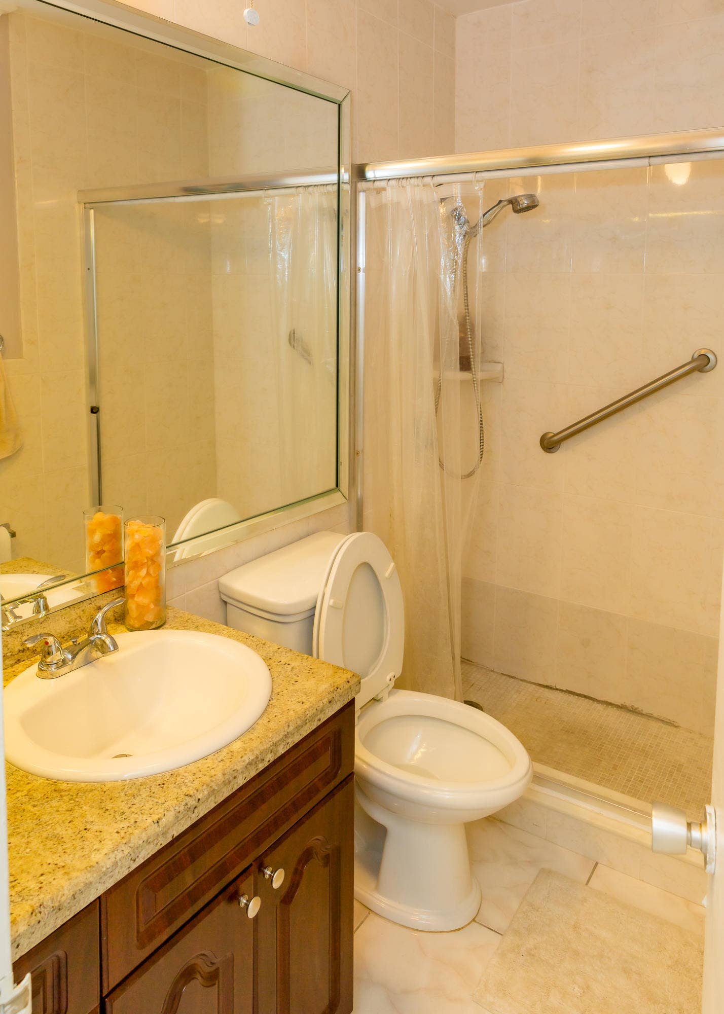 630 Layne Boulevard, #208, Hallandale Beach, Hallandale Beach, FL 33009 Bathroom featuring a vanity with a drop-in sink, granite-style countertop, and wood-finish cabinetry