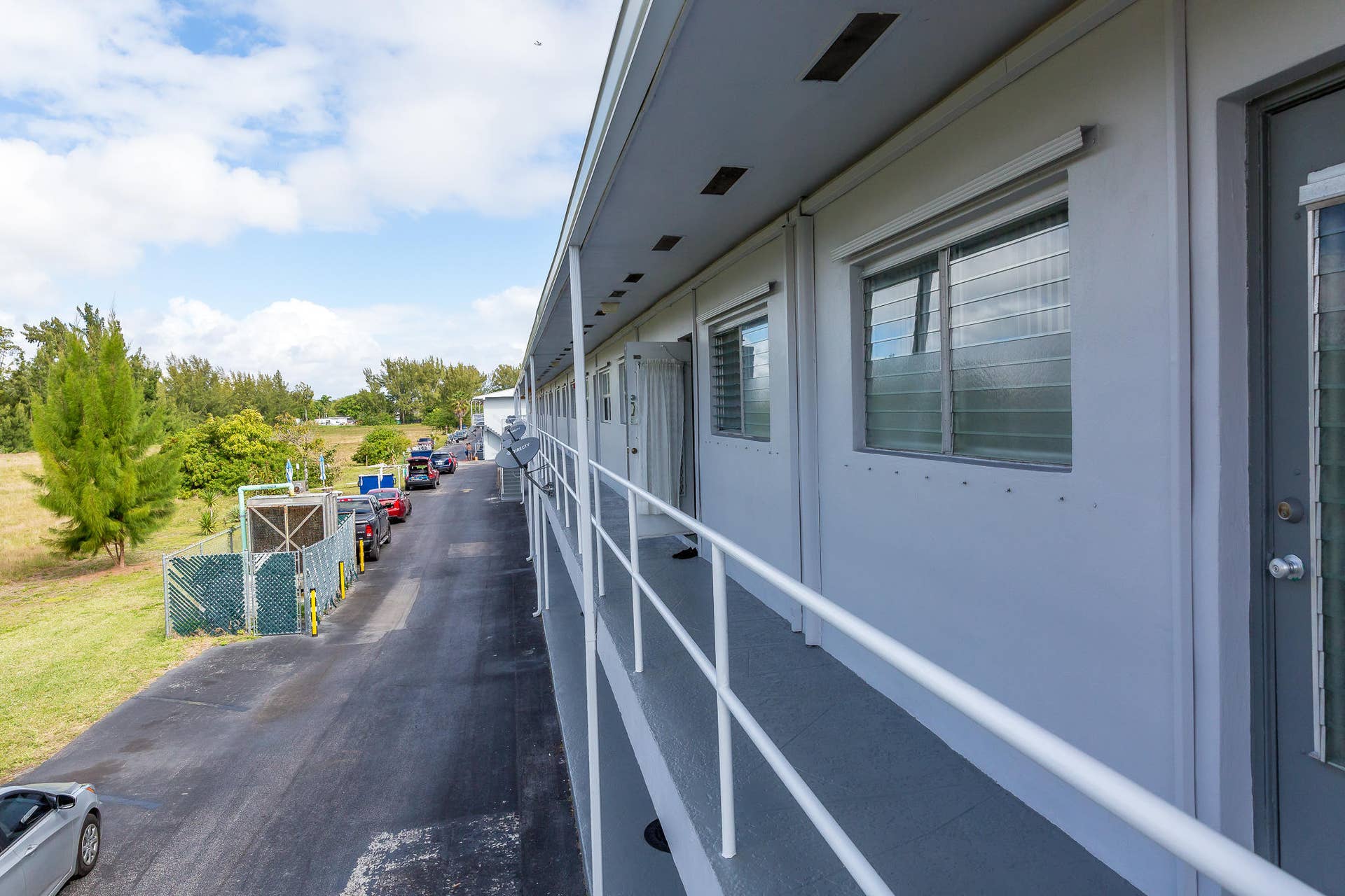 630 Layne Boulevard, #208, Hallandale Beach, Hallandale Beach, FL 33009 Covered exterior walkway featuring a ramp and railings