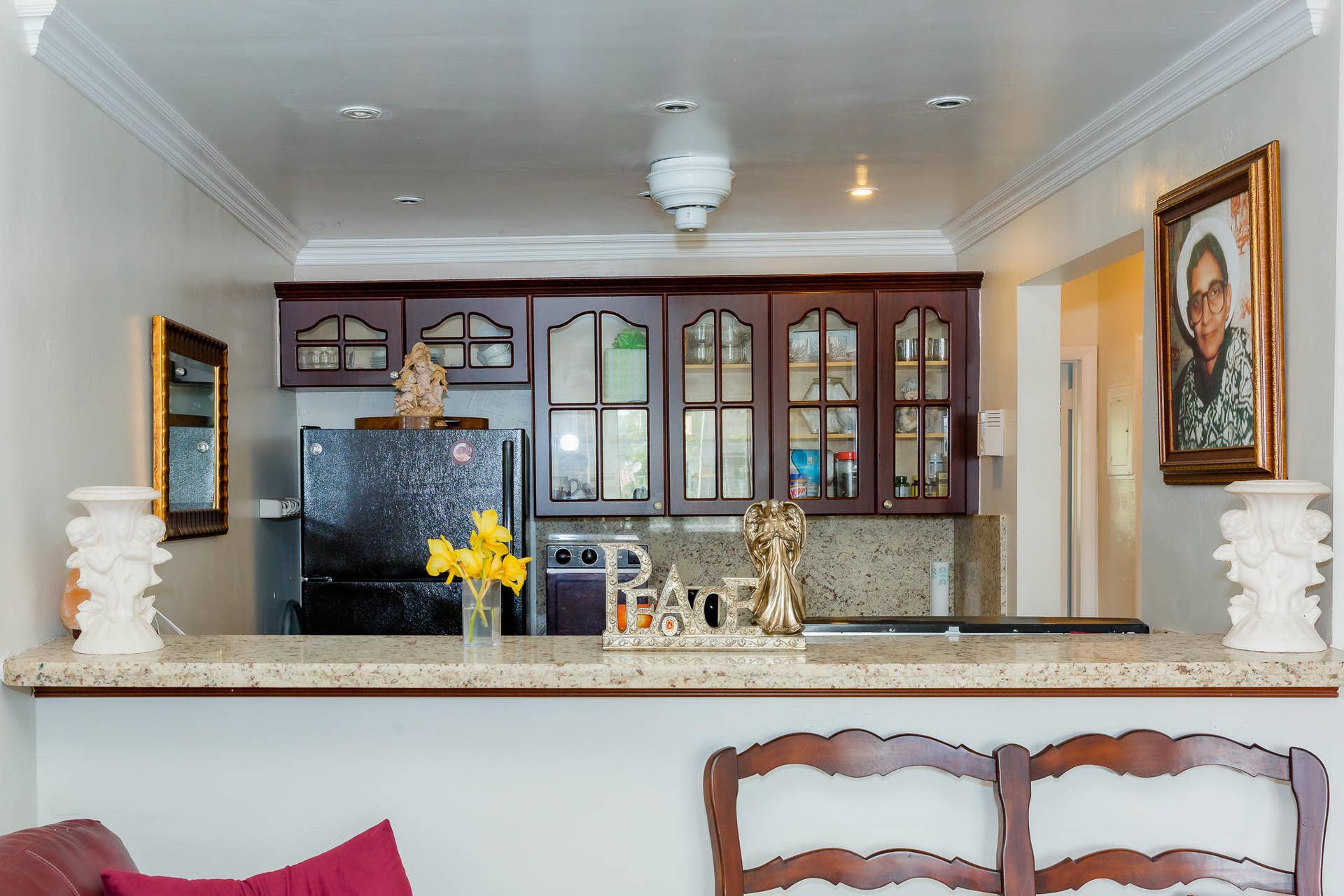 630 Layne Boulevard, #208, Hallandale Beach, Hallandale Beach, FL 33009 Kitchen featuring dark wood-finish cabinetry with glass paneling, black refrigerator, granite countertops, and recessed lighting