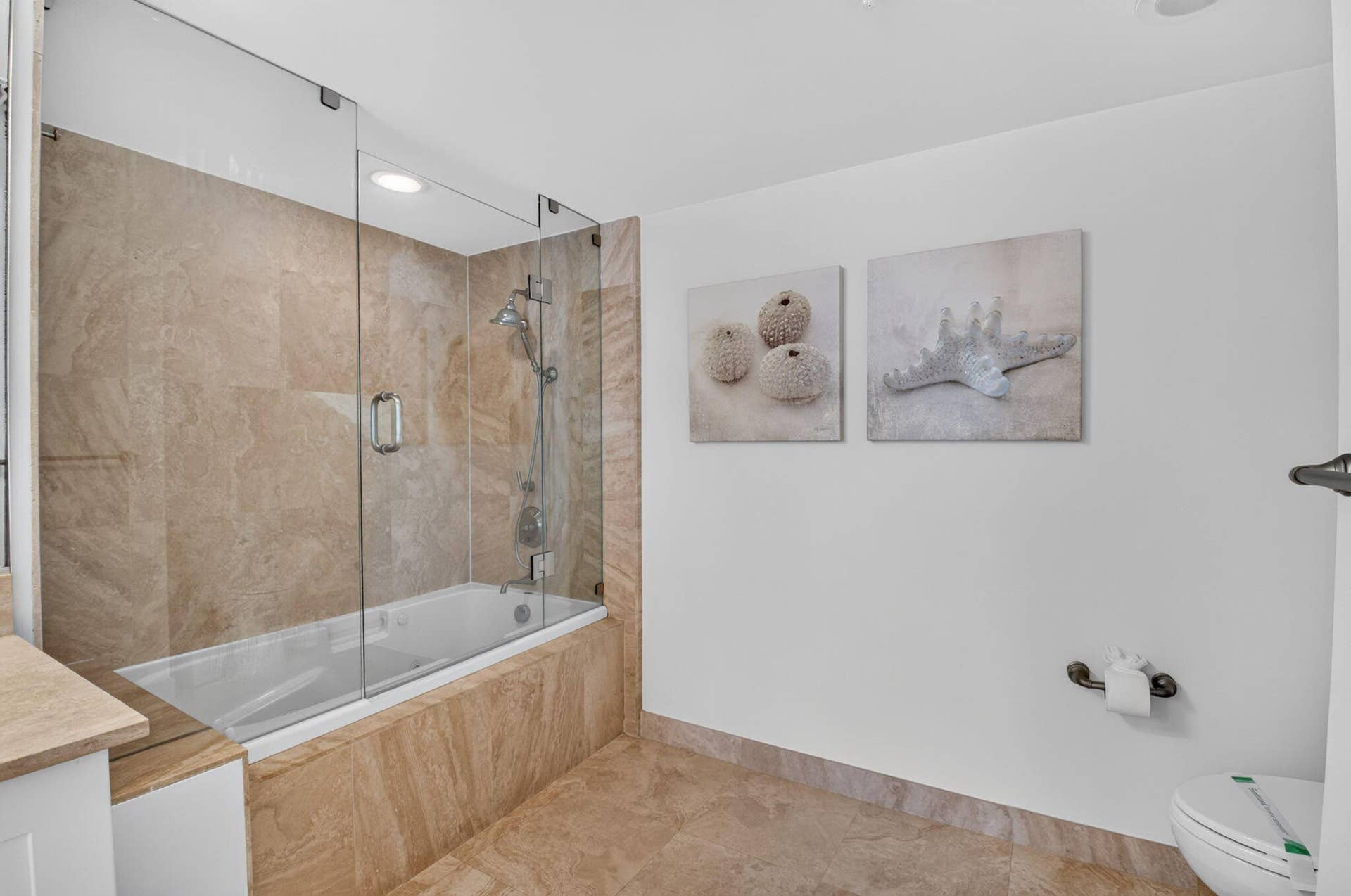 99 SE Mizner Boulevard, #Ph37, Boca Raton, FL 33432 Bathtub with glass shower enclosure.