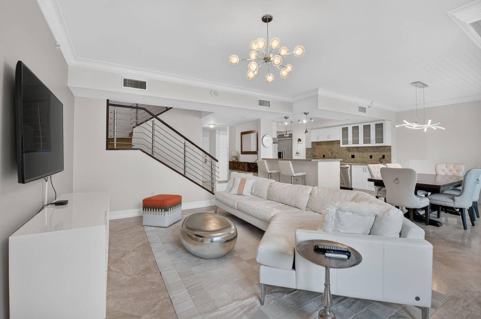 99 SE Mizner Boulevard, #Ph37, Boca Raton, FL 33432 Open-concept living space featuring high ceilings, crown molding, and large format floor tile.