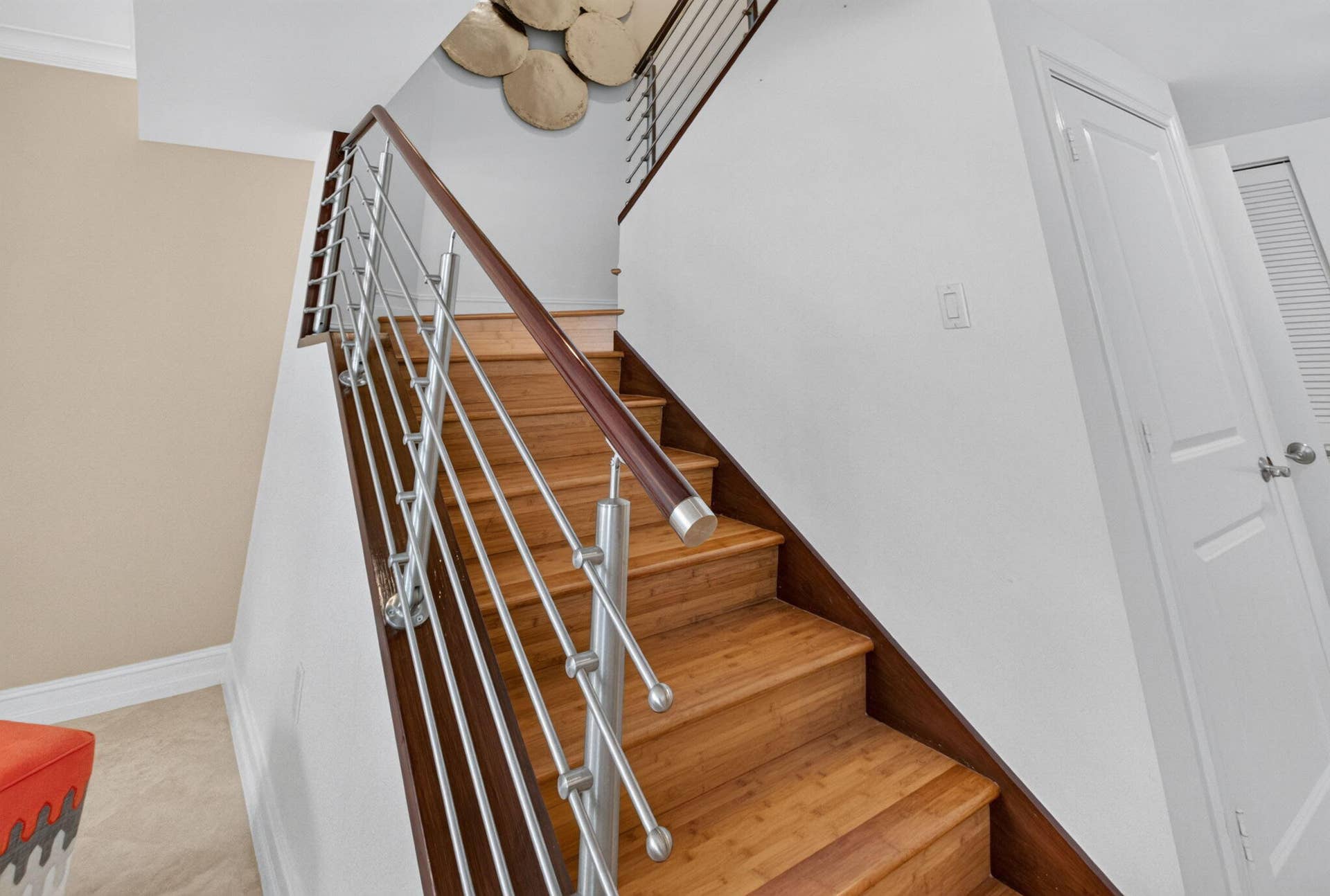 99 SE Mizner Boulevard, #Ph37, Boca Raton, FL 33432 Wood-finish stairs with a stainless steel and wood railing.