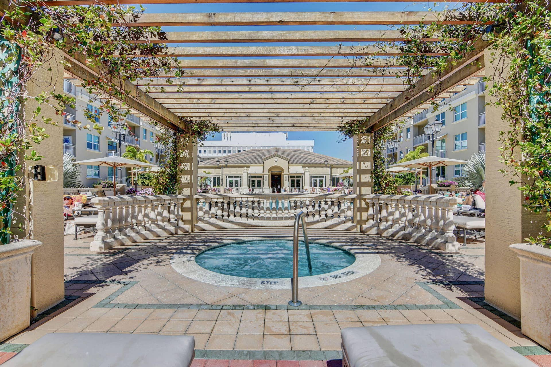 99 SE Mizner Boulevard, #Ph37, Boca Raton, FL 33432 Outdoor spa with surrounding patterned paver patio, wood pergola with climbing vines.