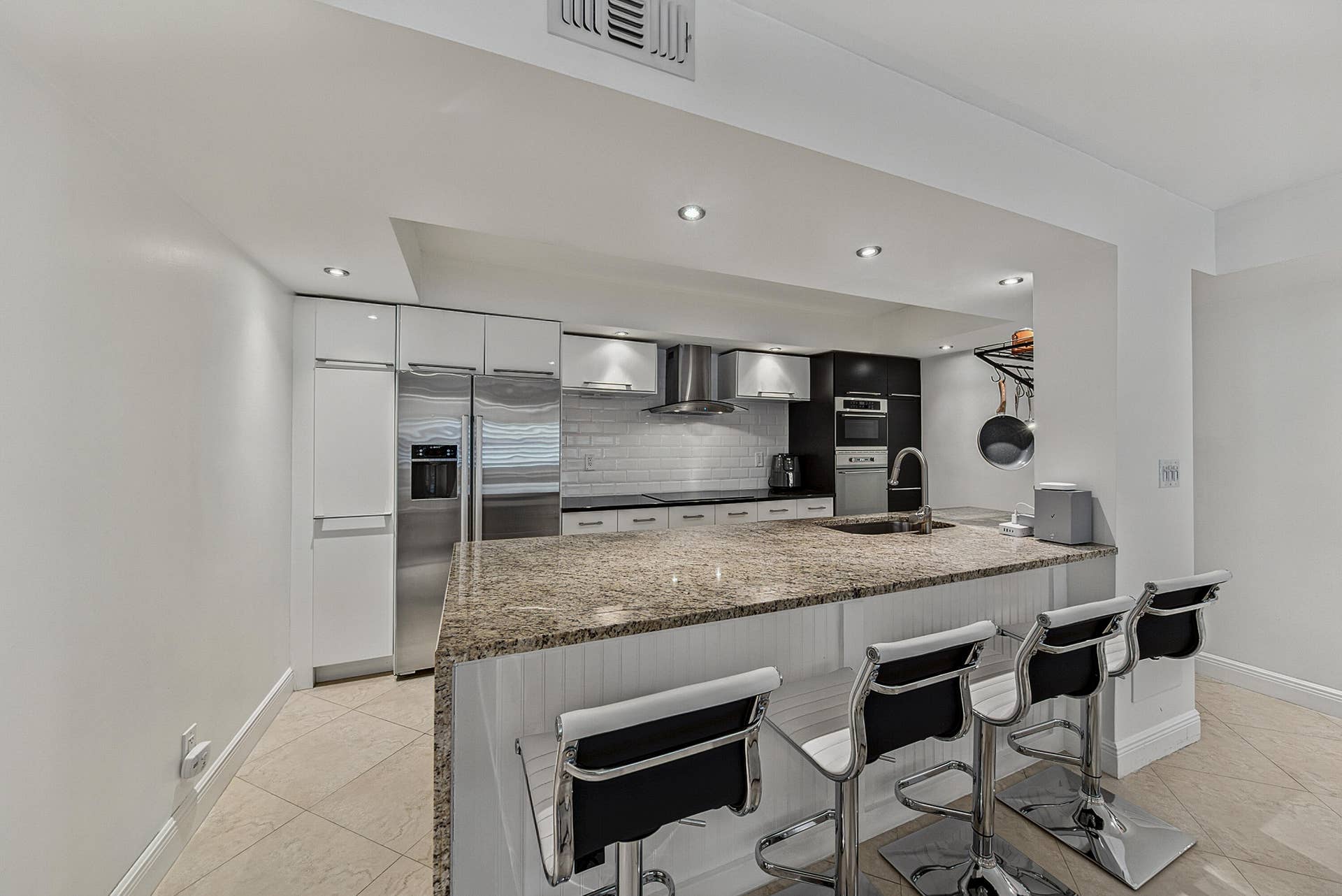 2900 NE 30th Street, #G1, Fort Lauderdale, FL 33306 Kitchen with oversized island, granite countertop with waterfall side