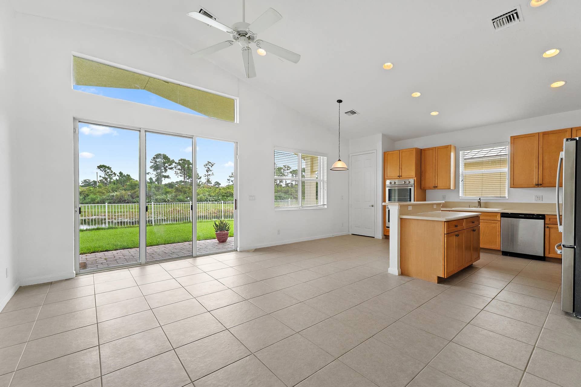 5183 SE Graham Drive, Stuart, FL 34997 The view starts the moment you walk in. Tall sliders and the clerestory window frame the pond and preserve from the great room and kitchen.