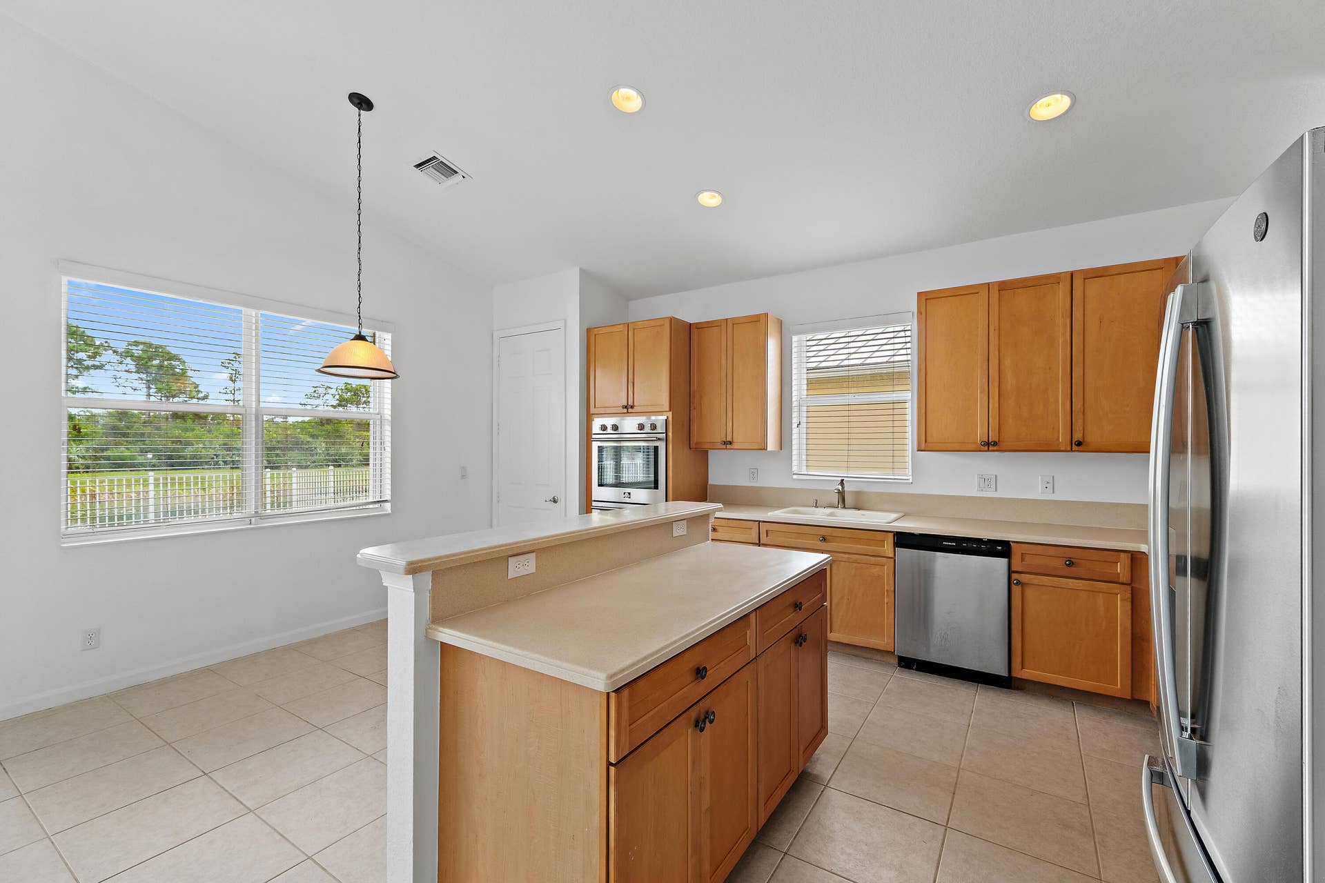 5183 SE Graham Drive, Stuart, FL 34997 The kitchen is the heart of this home. It opens to the family room, with an island for gathering and beautiful pond and preserve views from both spaces.