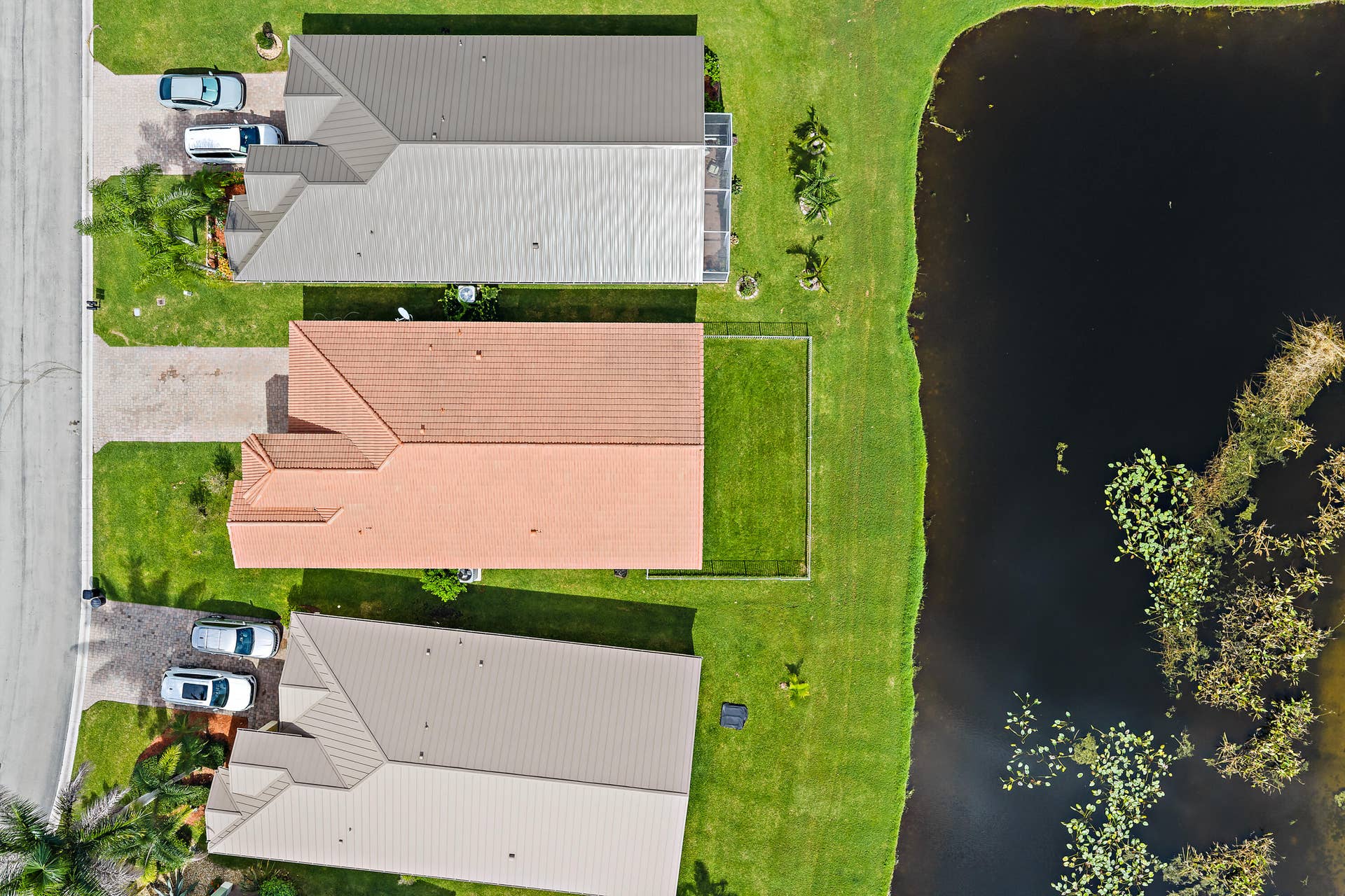 5183 SE Graham Drive, Stuart, FL 34997 This aerial view shows what makes this home special: a peaceful pond right behind it, framed by lush trees and preserve. The home sits on a well-kept street in Martins Crossing, with water and nature views from the back of the house. Its a quiet, private setting youll love coming home to.