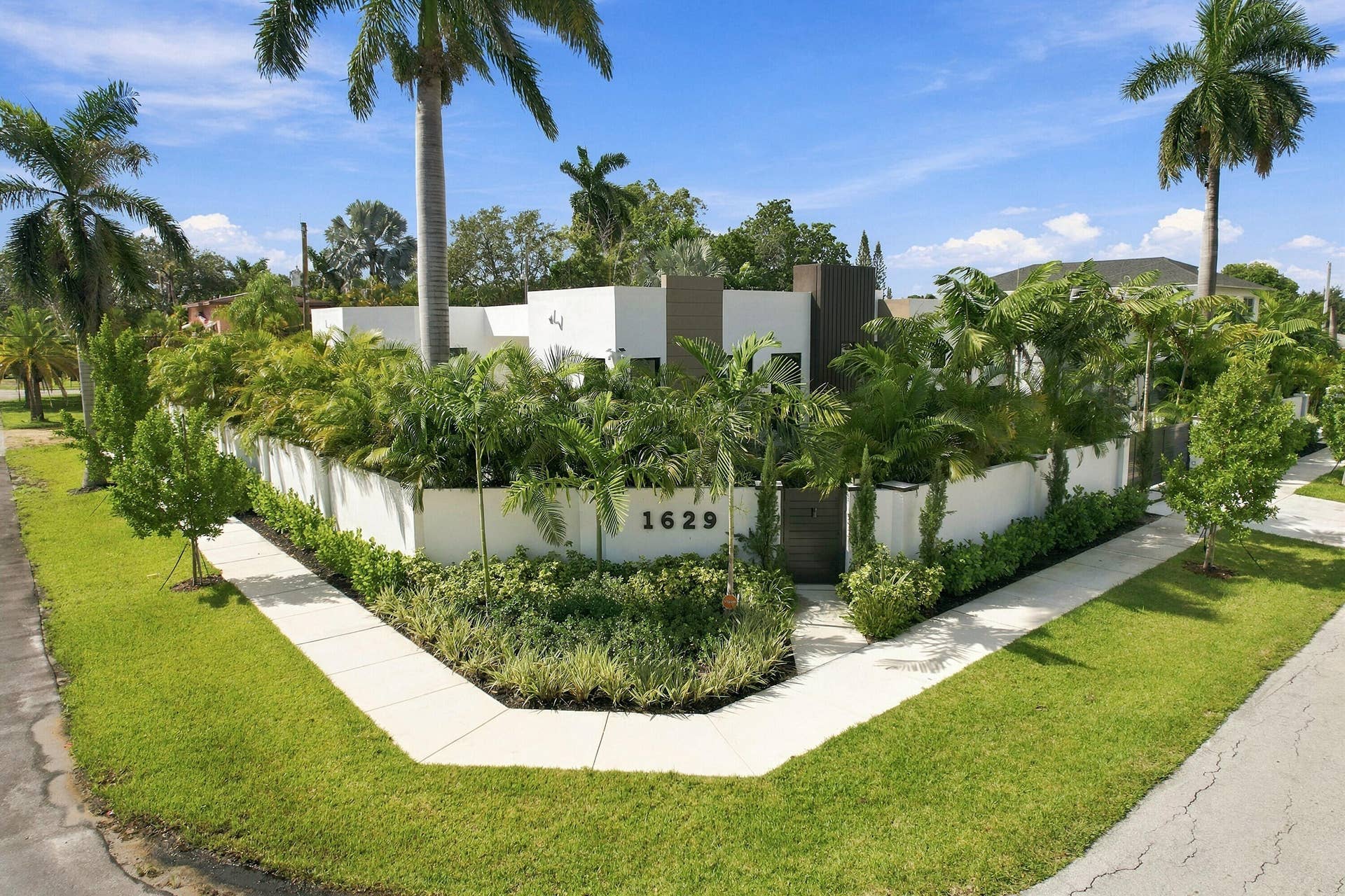 Modern residence featuring clean-lined architectural design with stucco exterior and dark accent detailing