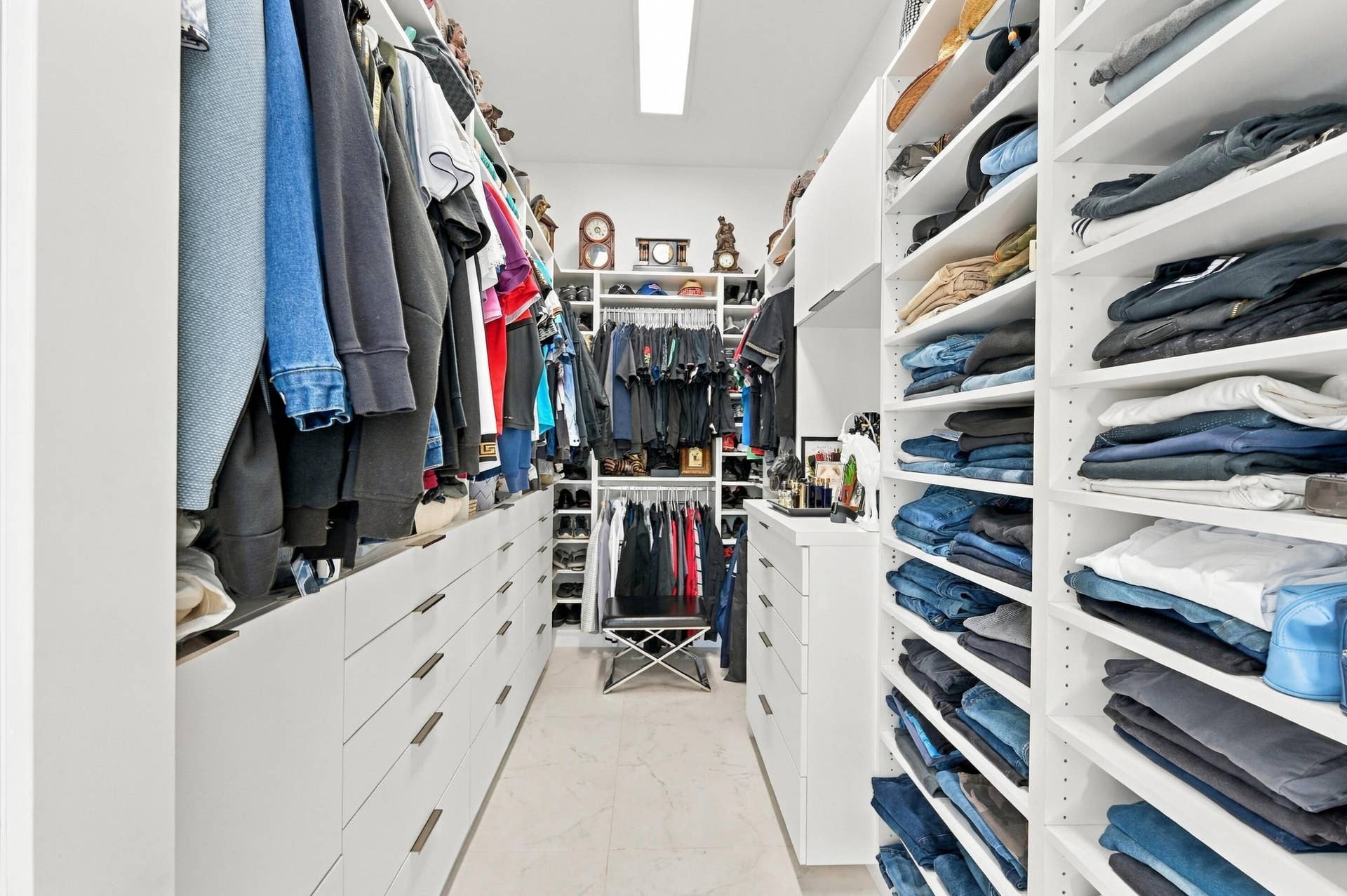 110 NE 16TH Place, Fort Lauderdale, FL 33305 Custom closet system featuring extensive shelving, multiple hanging rods, built-in drawers, and overhead storage