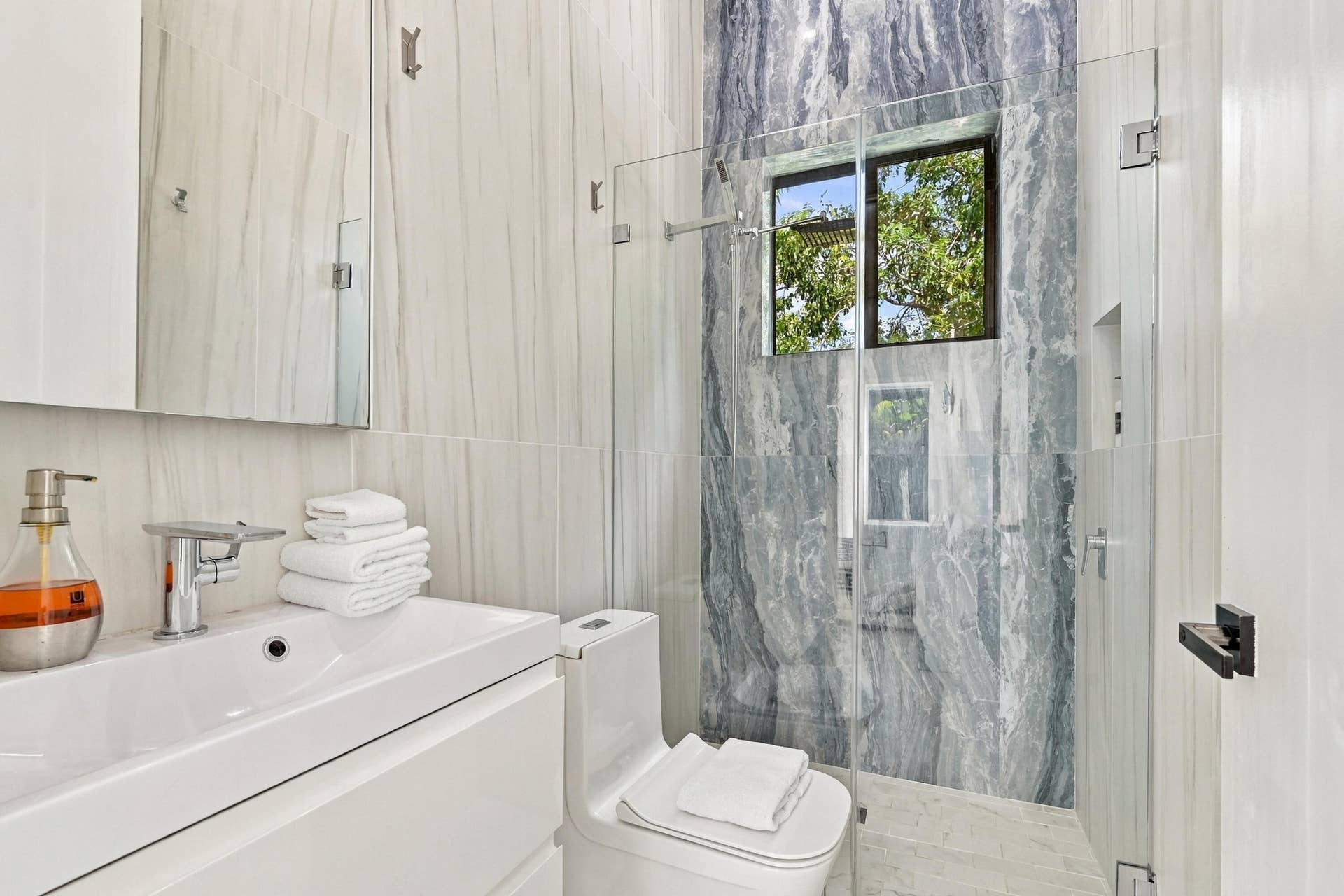 110 NE 16TH Place, Fort Lauderdale, FL 33305 White vanity with an integrated basin and polished chrome faucet
