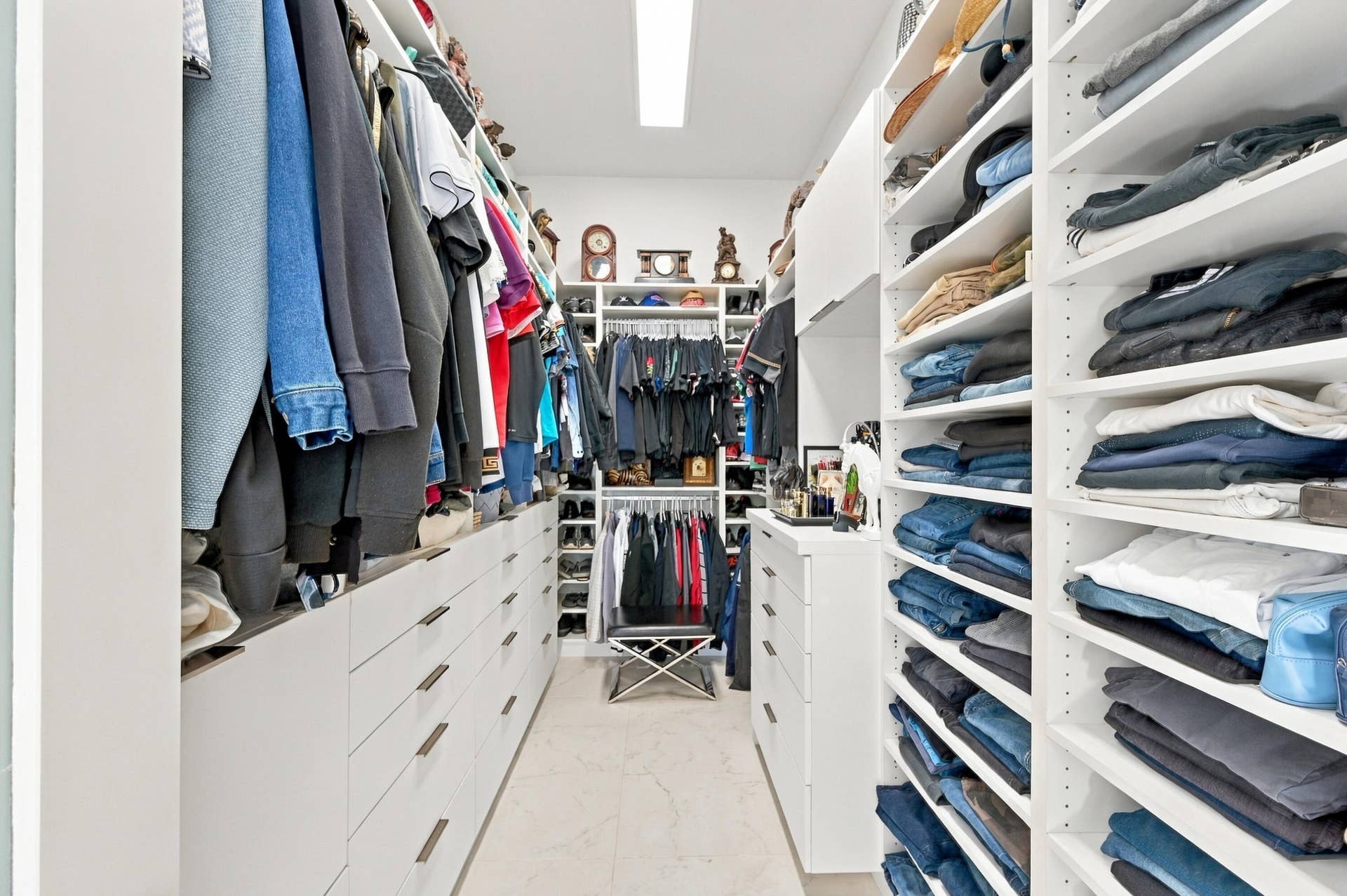 110 NE 16TH Place, Fort Lauderdale, FL 33305 Custom closet system featuring built-in shelving, drawers with elongated pulls, and hanging storage