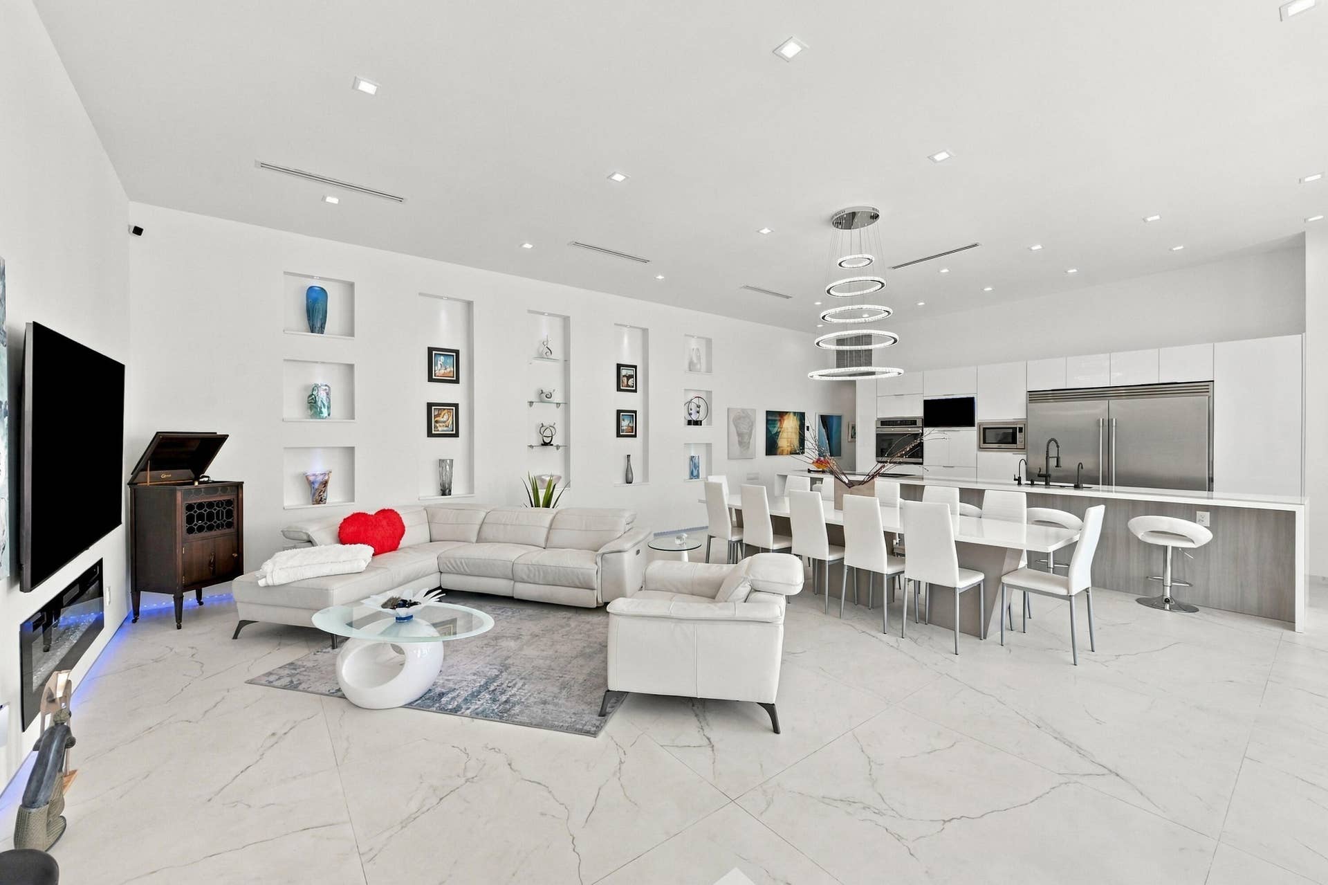 110 NE 16TH Place, Fort Lauderdale, FL 33305 Expansive open-concept living area featuring large format white tile flooring, recessed lighting, and built-in wall niches
