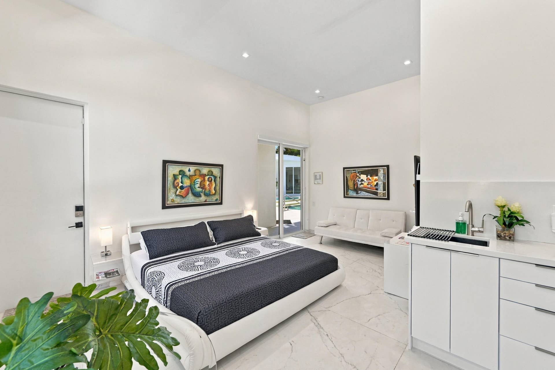 110 NE 16TH Place, Fort Lauderdale, FL 33305 White flat-panel cabinetry with a stainless steel sink, a white countertop, and recessed lighting