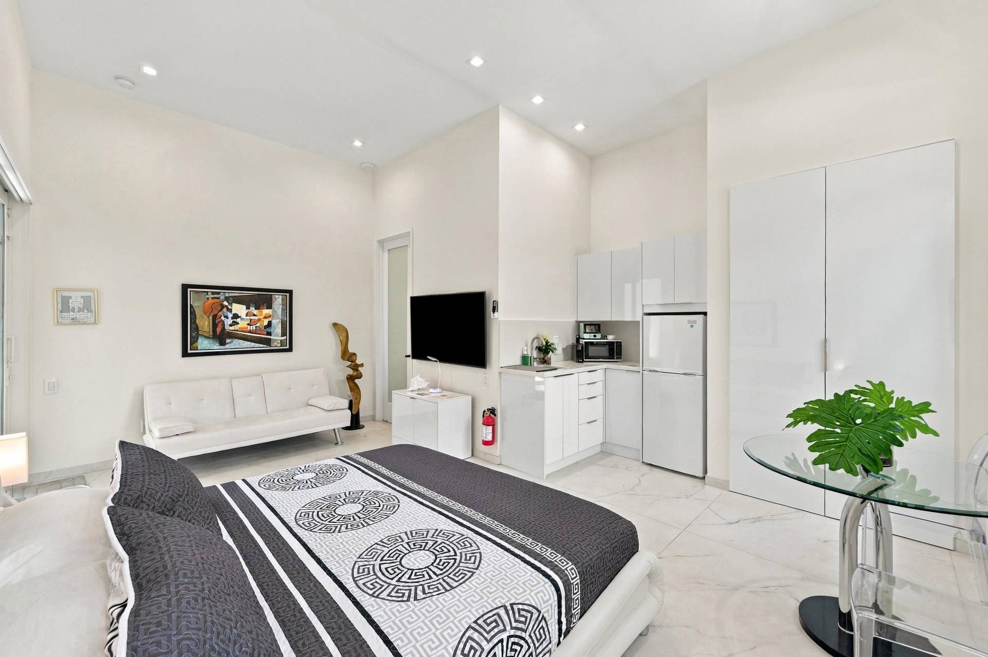 110 NE 16TH Place, Fort Lauderdale, FL 33305 Recessed lighting illuminates the high ceilings and light-toned walls