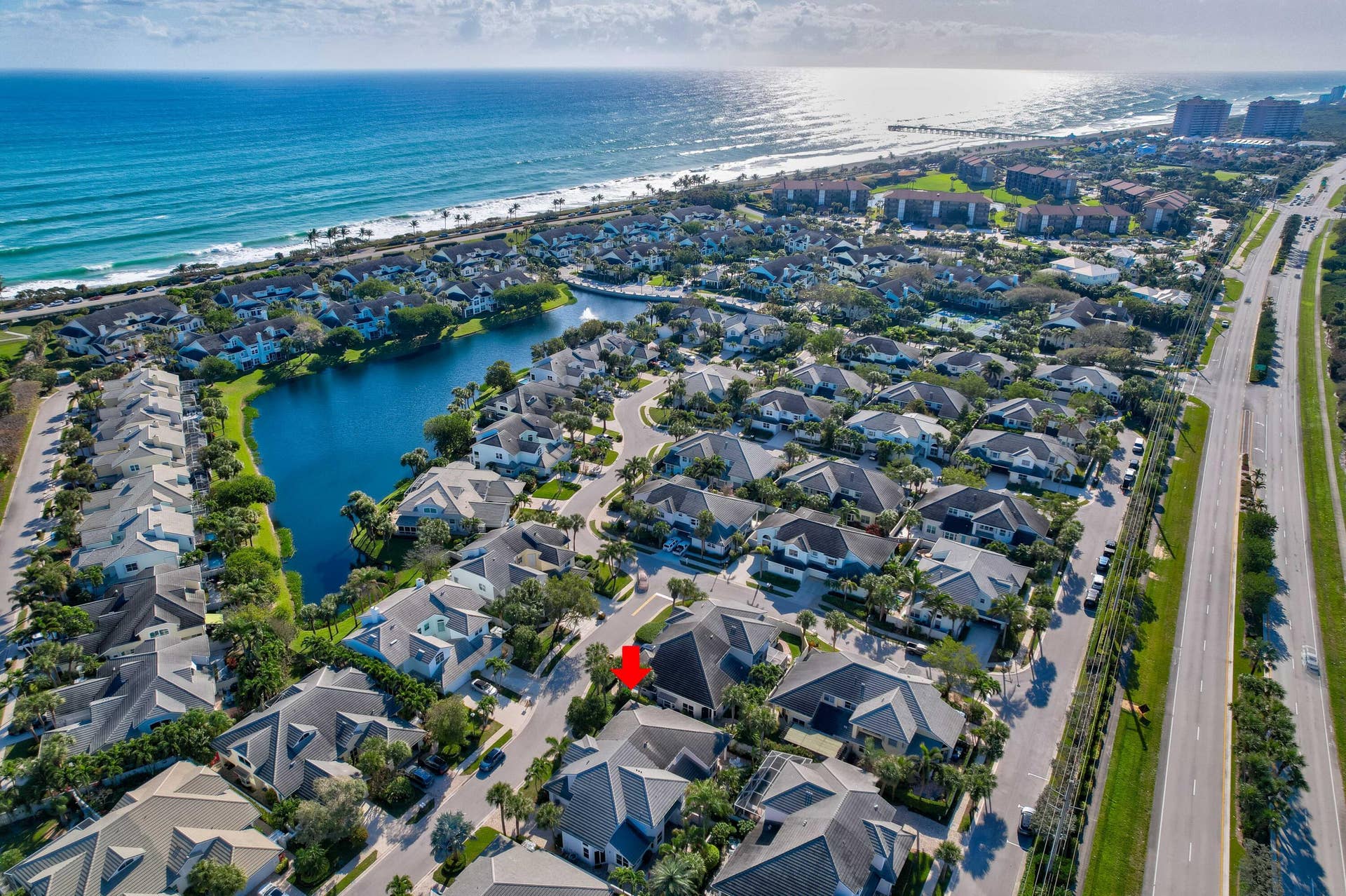 2043 Staysail Lane, Jupiter, Jupiter, FL 33477 Coastal community with lake and ocean frontage, featuring residential properties with mature landscaping and convenient road access