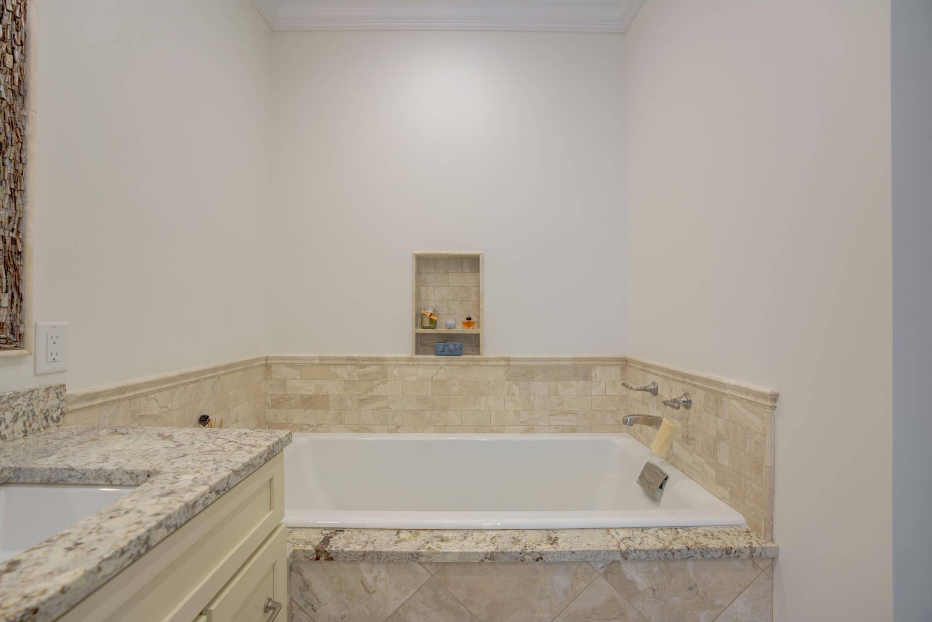2043 Staysail Lane, Jupiter, Jupiter, FL 33477 Built-in soaking tub with polished chrome fixtures, surrounded by neutral-toned tile and a recessed shelving niche