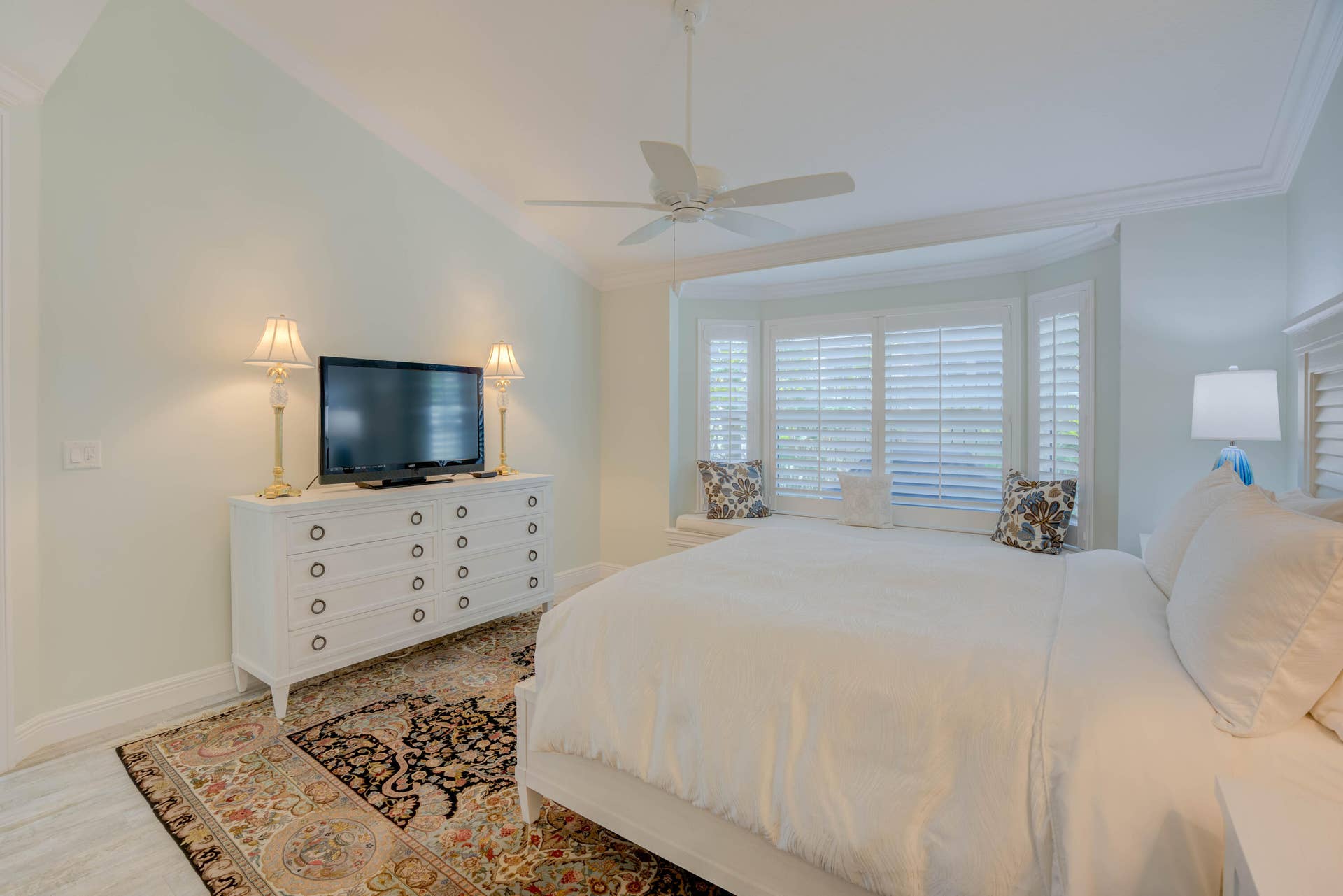 2043 Staysail Lane, Jupiter, Jupiter, FL 33477 Bay window with plantation shutters, vaulted ceiling, crown molding, and ceiling fan