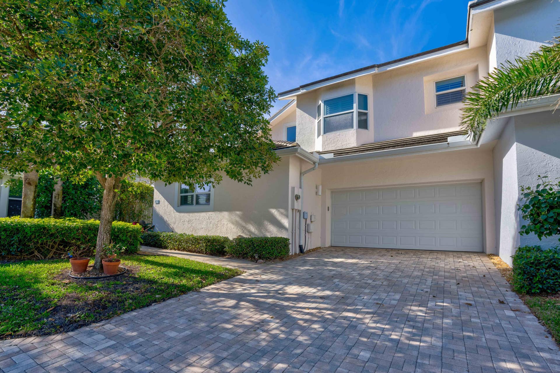 2043 Staysail Lane, Jupiter, Jupiter, FL 33477 Stucco exterior with a two-story design, paver driveway, and an integrated two-car garage