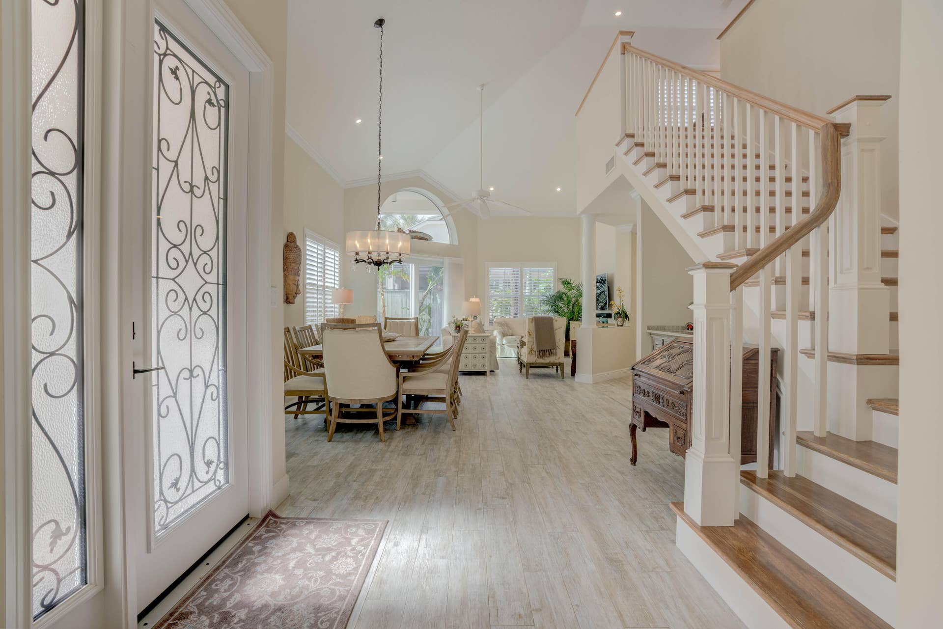 2043 Staysail Lane, Jupiter, Jupiter, FL 33477 Entryway featuring decorative glass paneled doors, vaulted ceilings, and light wood-finish flooring