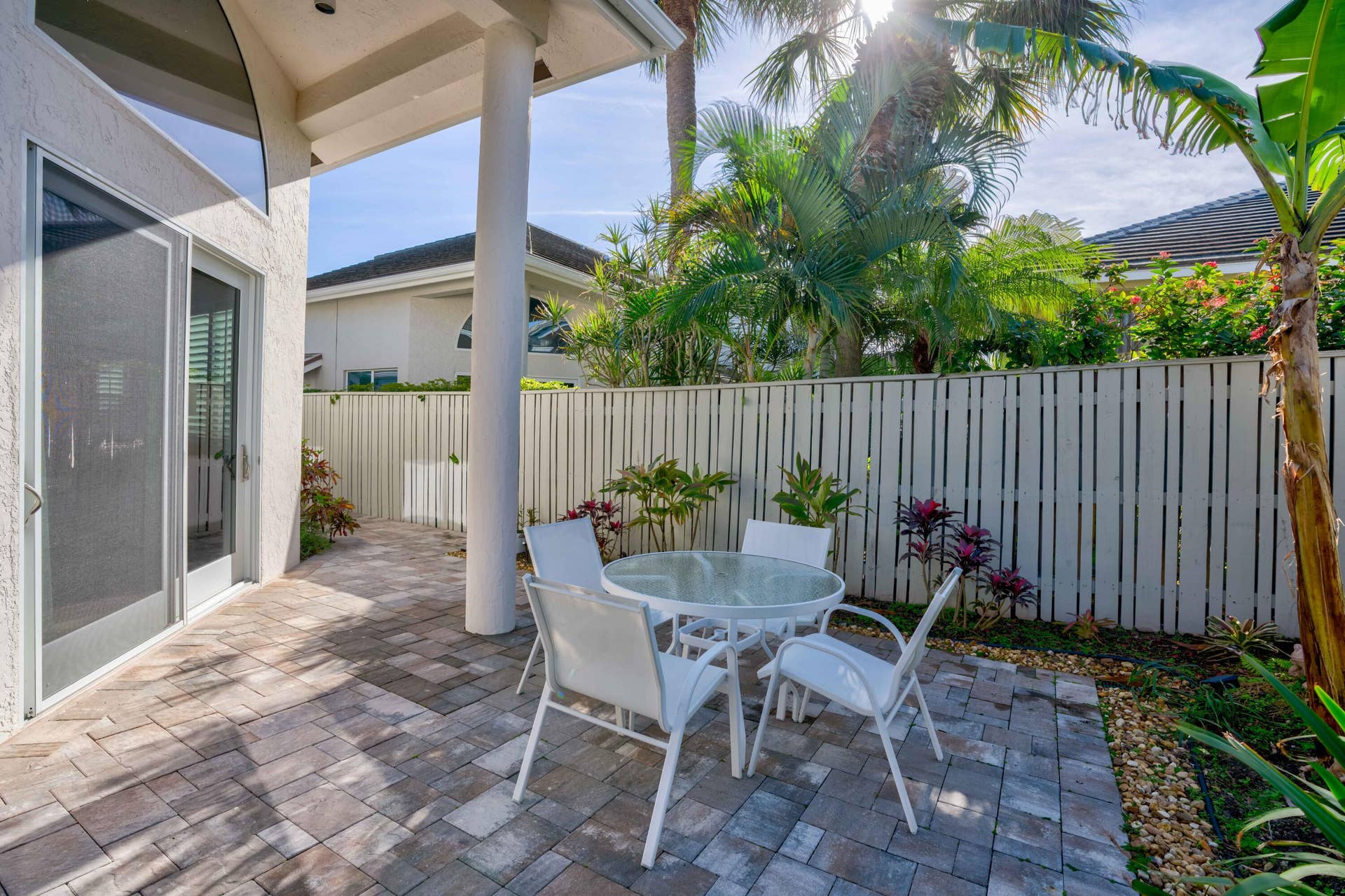 2043 Staysail Lane, Jupiter, Jupiter, FL 33477 Paved patio area featuring columns and a sliding glass door