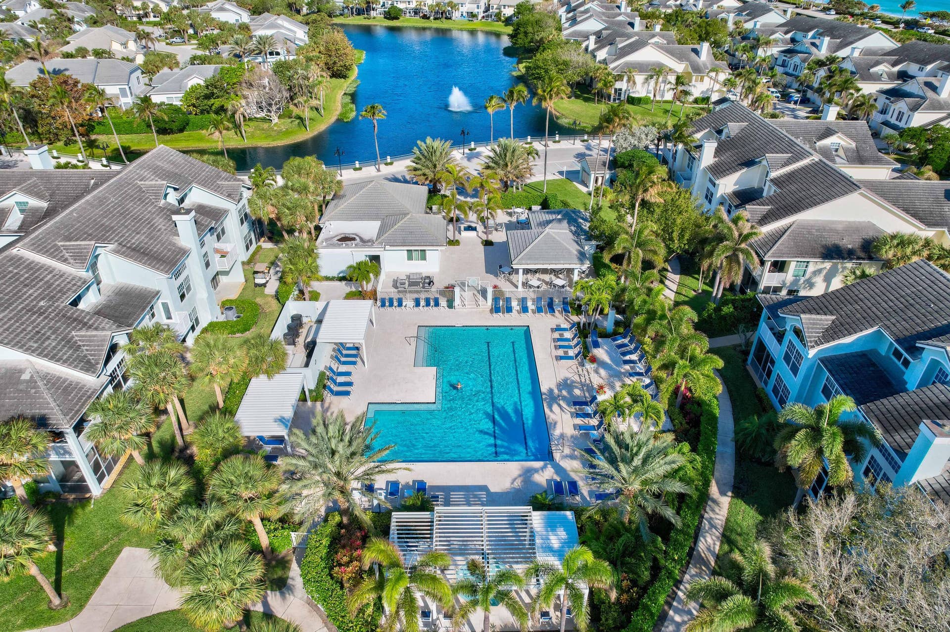 2043 Staysail Lane, Jupiter, Jupiter, FL 33477 Expansive aquatic amenity featuring a large swimming pool, surrounding lounge area, and a shaded pergola