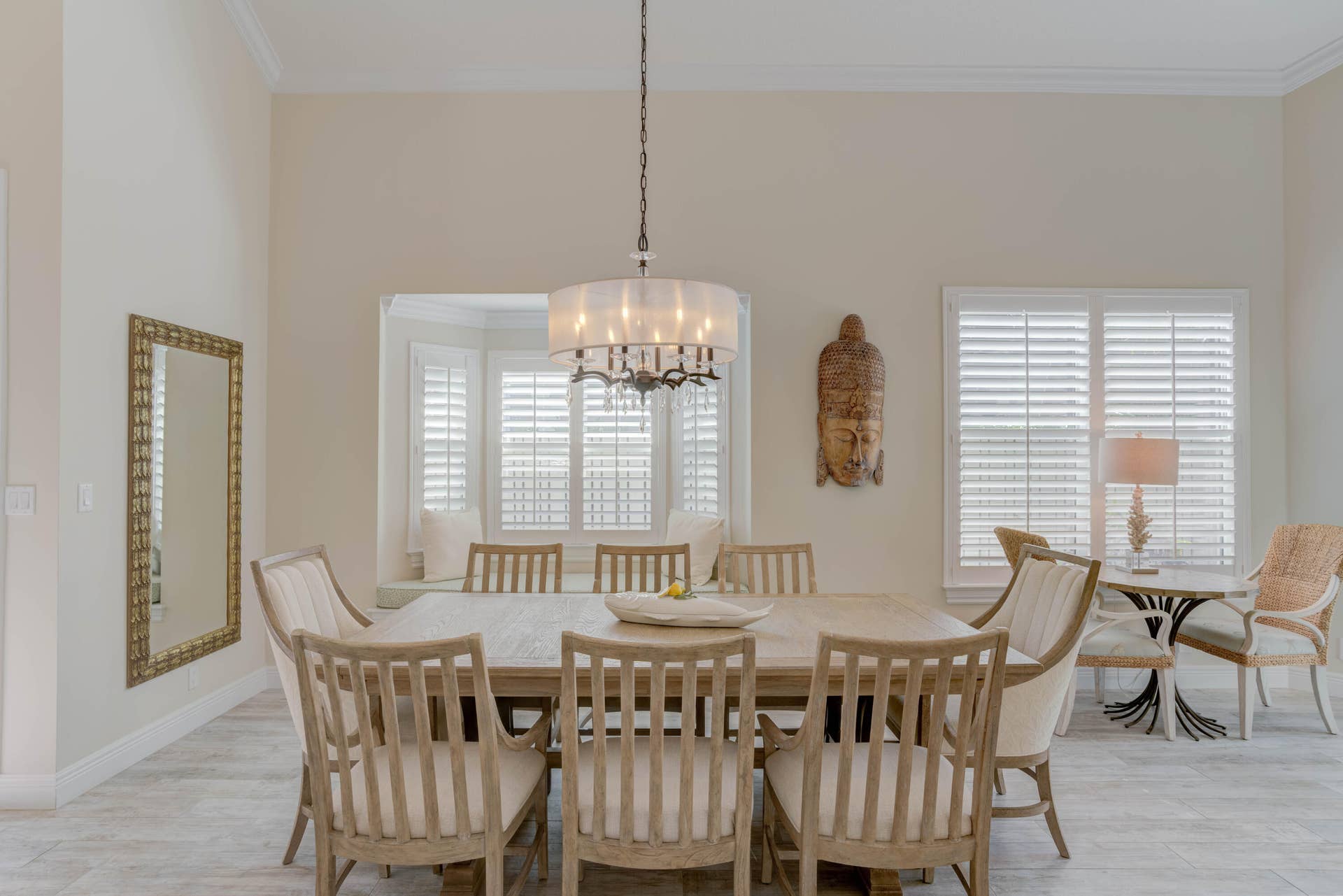 2043 Staysail Lane, Jupiter, Jupiter, FL 33477 Tray ceiling with crown molding, bay window with built-in bench seating, plantation shutters, tiled flooring, and a chandelier with a fabric shade