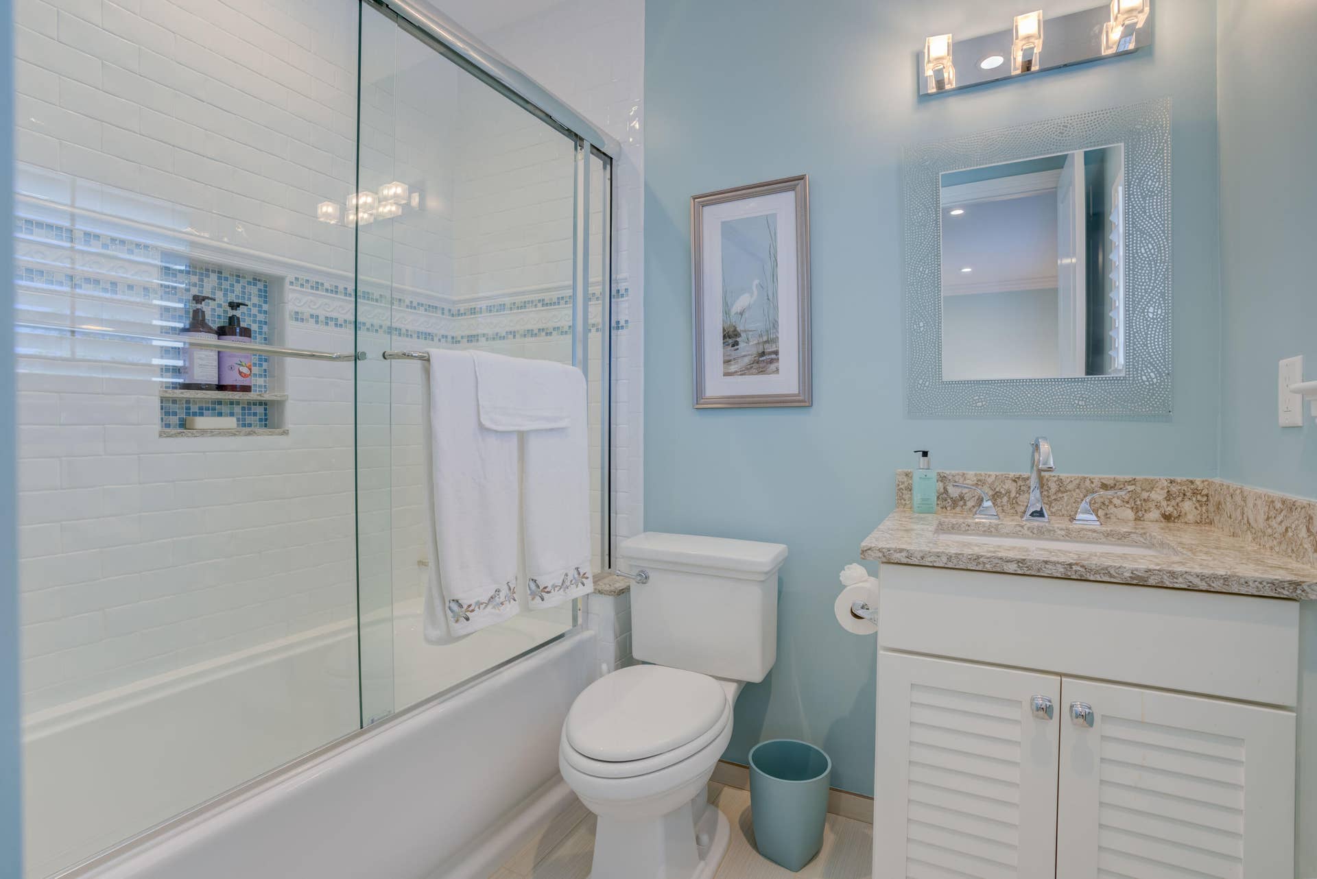 2043 Staysail Lane, Jupiter, Jupiter, FL 33477 Bathtub with glass sliding doors, built-in shower niche, and white subway tile surround