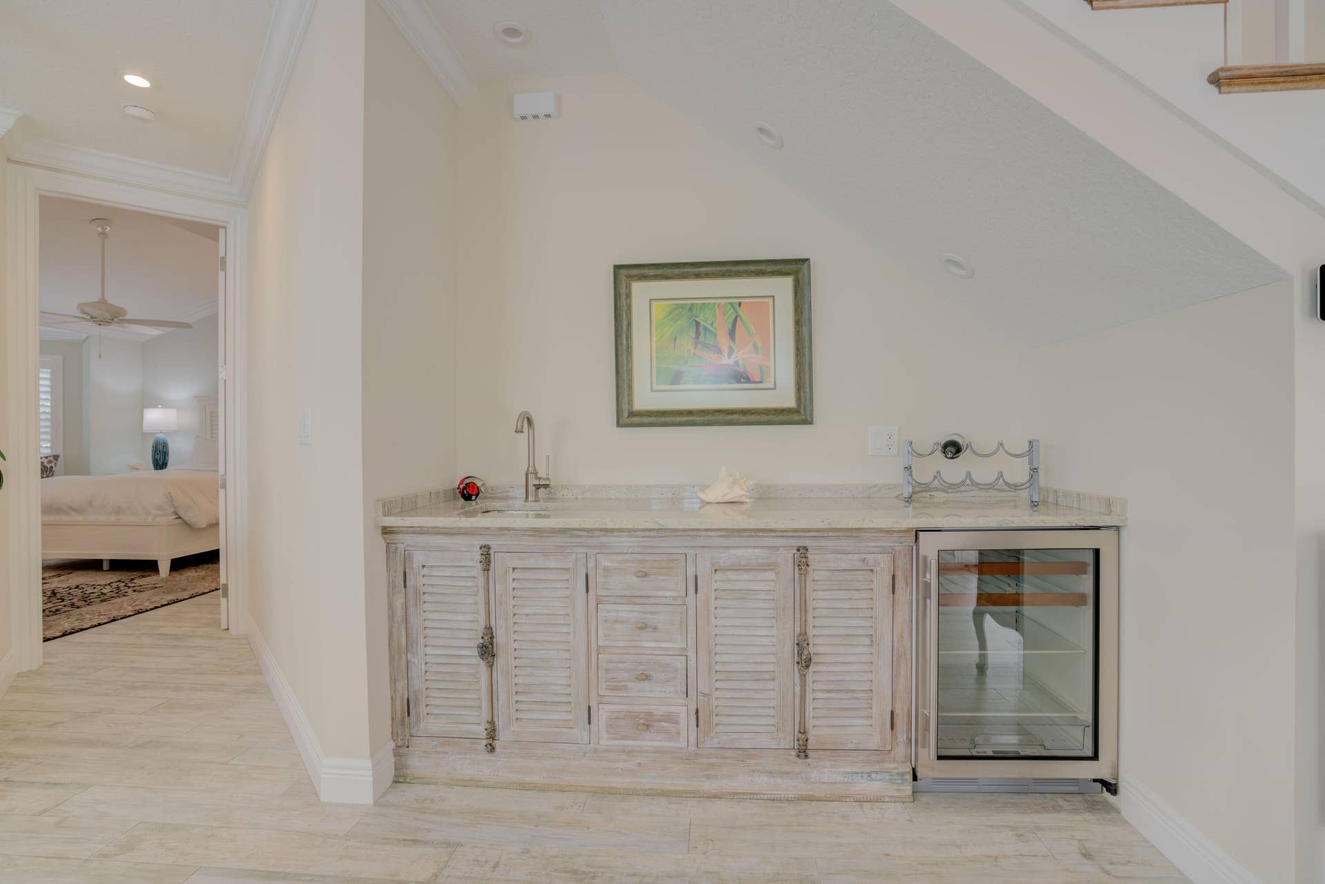 2043 Staysail Lane, Jupiter, Jupiter, FL 33477 Built-in wet bar with a single basin sink, integrated beverage cooler, and distressed wood-finish cabinetry, complemented by light-toned flooring