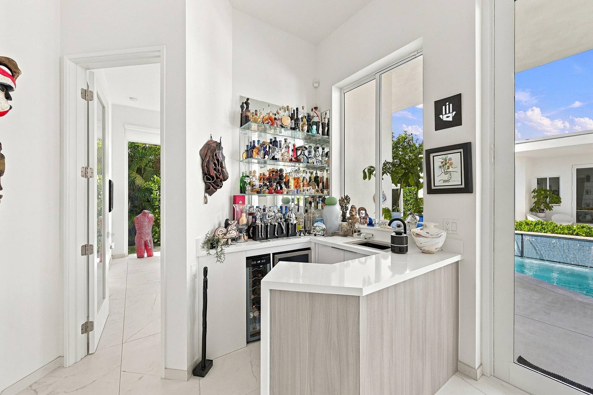 Built-in wet bar with a white countertop and wood-finish cabinetry