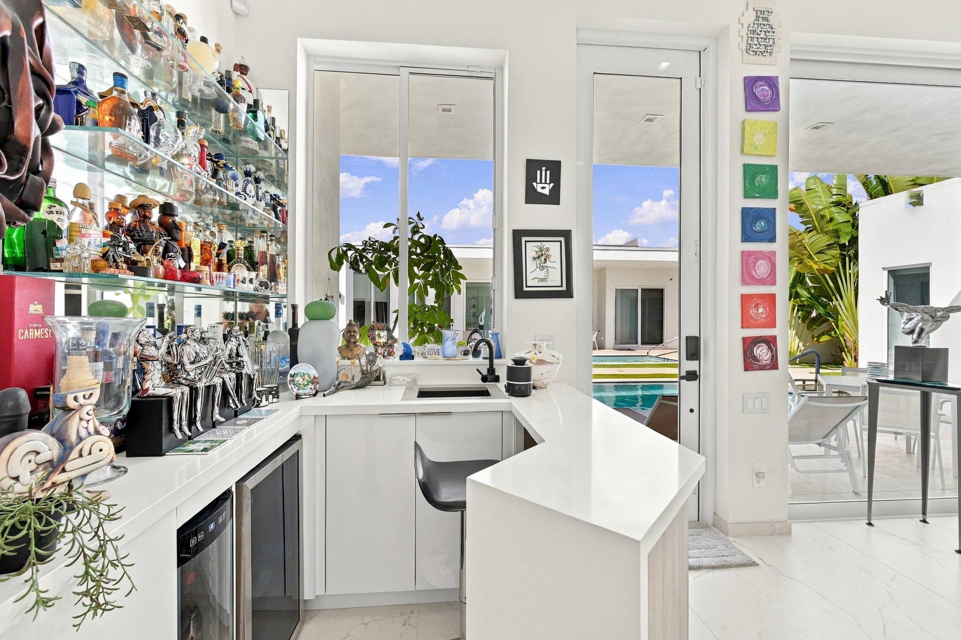 Wet bar featuring a white countertop, built-in beverage refrigerator, and open shelving