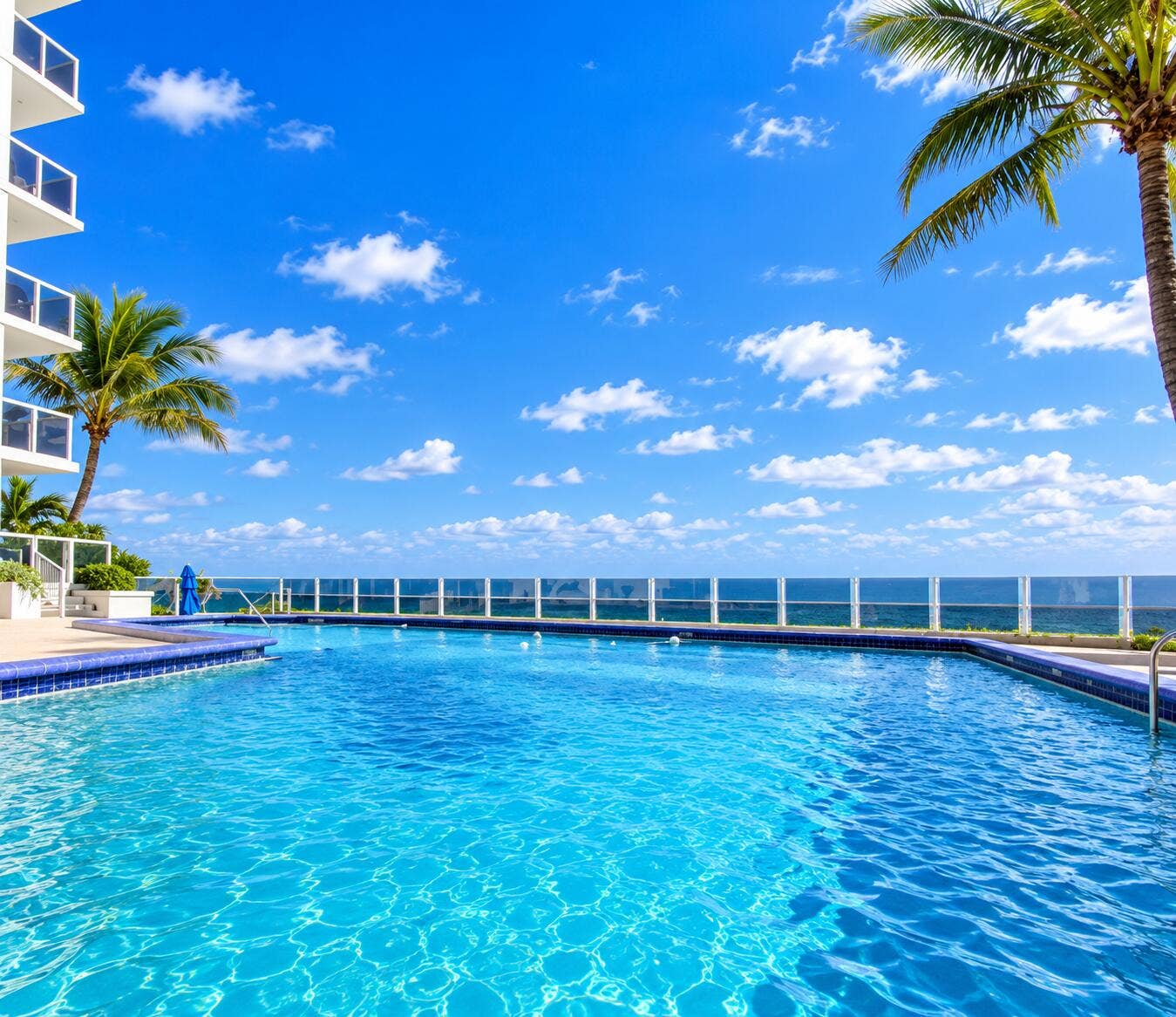 Resort-style swimming pool featuring a tiled edge and integrated spa