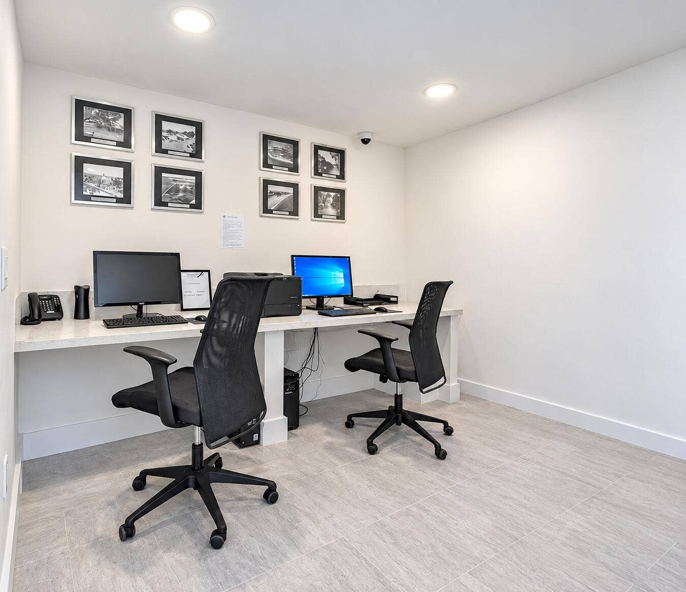 Dedicated workspace featuring a long countertop, recessed lighting, and tile flooring