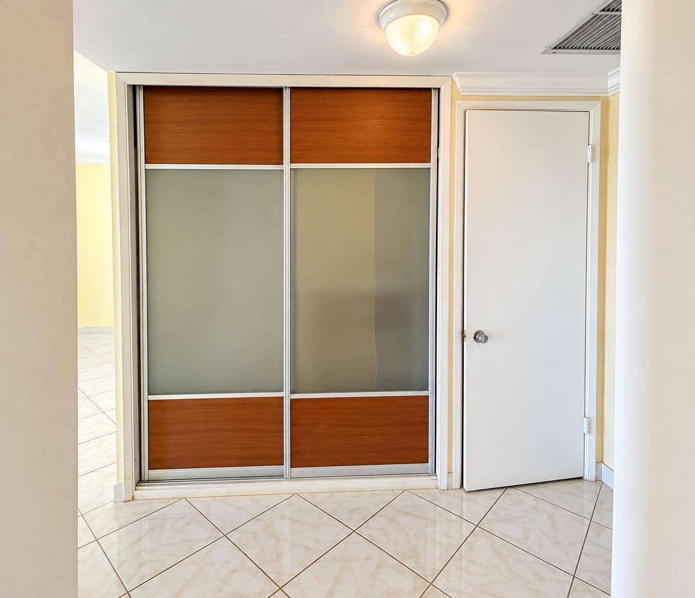 Sliding closet doors with wood-finish and frosted panels