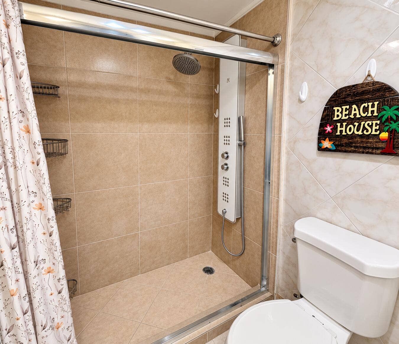 Glass-enclosed shower with a multi-function shower panel, rainfall shower head, and tiled walls